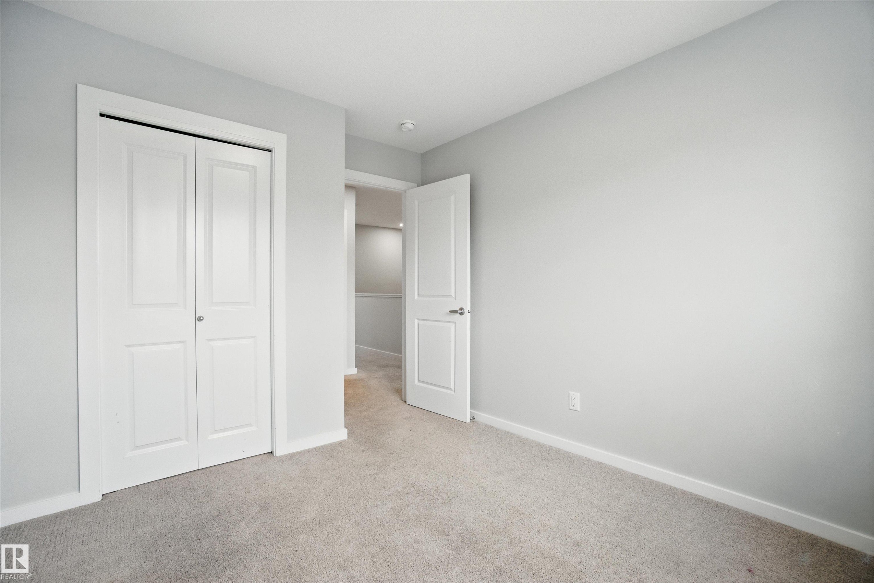 Unfurnished bedroom featuring carpet floors and a closet - 20727 25 Ave, Edmonton, AB - Indoor