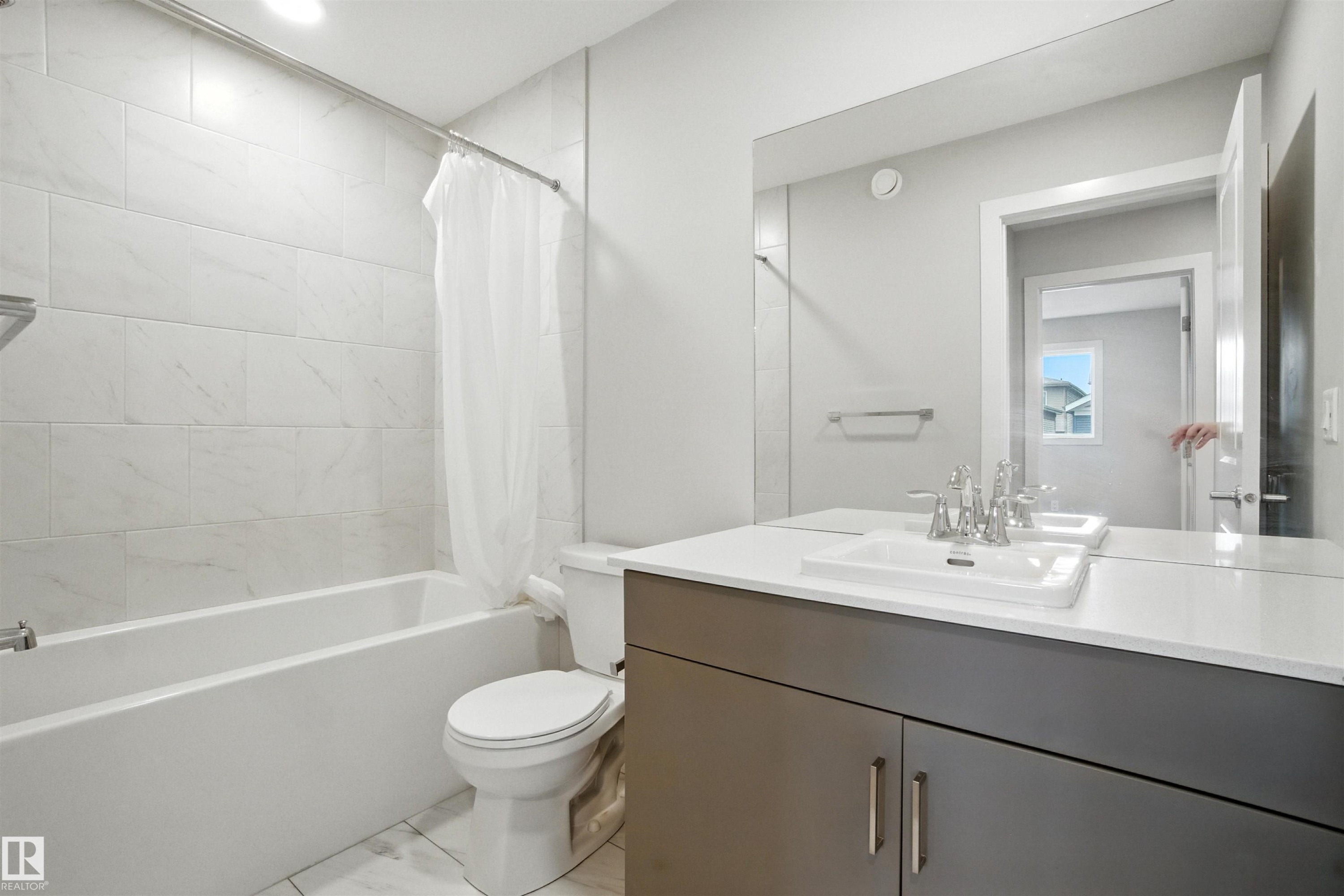 Full bathroom with shower / tub combo with curtain and vanity - 20727 25 Ave, Edmonton, AB - Indoor Photo Showing Bathroom