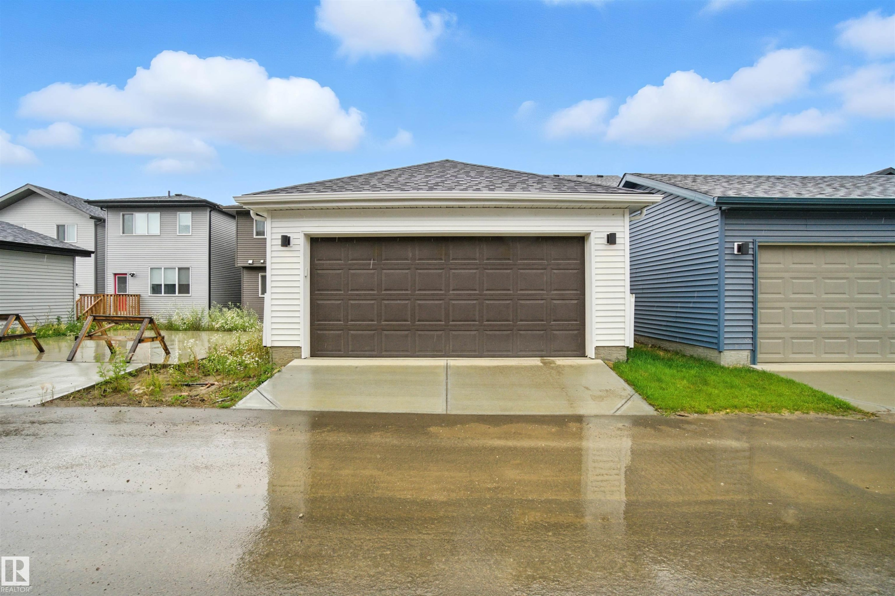 View of front of home featuring a garage, roof with shingles, and concrete driveway - 20727 25 Ave, Edmonton, AB - Outdoor