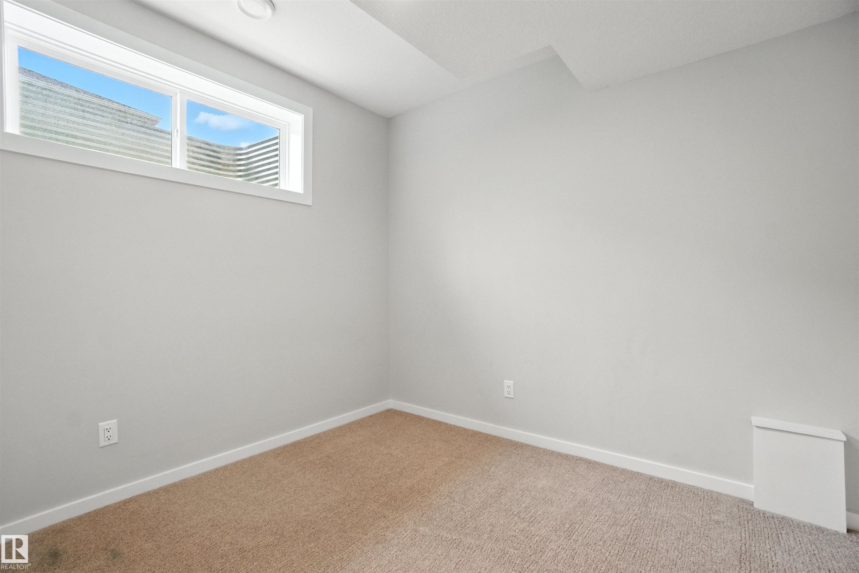 Unfurnished room featuring baseboards and carpet floors - 20727 25 Ave, Edmonton, AB - Indoor Photo Showing Other Room
