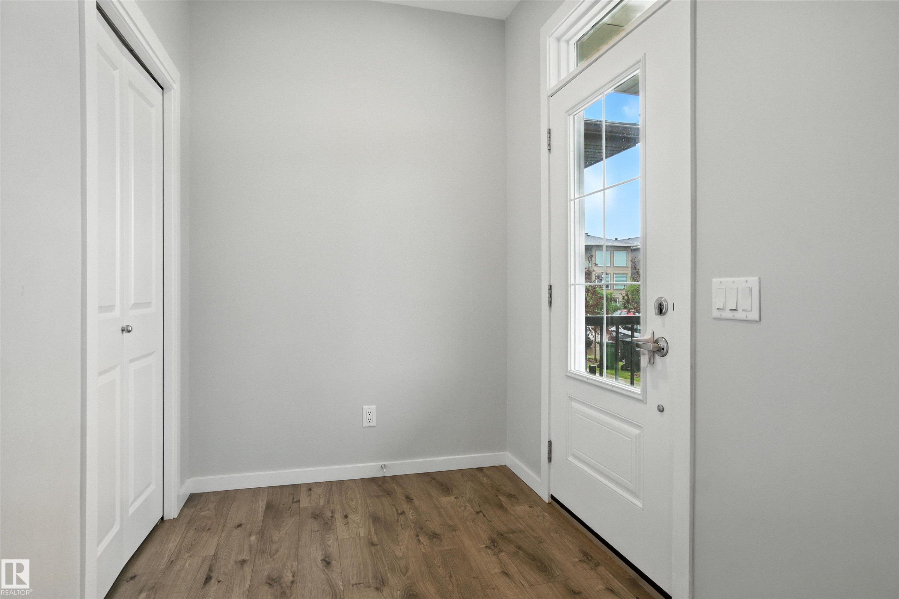 Entryway featuring wood finished floors and baseboards - 20727 25 Ave, Edmonton, AB - Indoor Photo Showing Other Room
