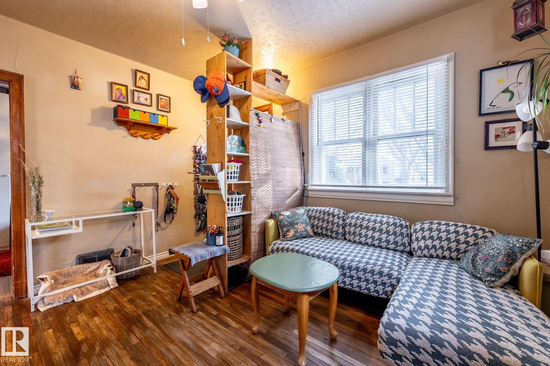 Living room with dark wood-type flooring and a textured ceiling - 11240 84 Street, Edmonton, AB - Indoor