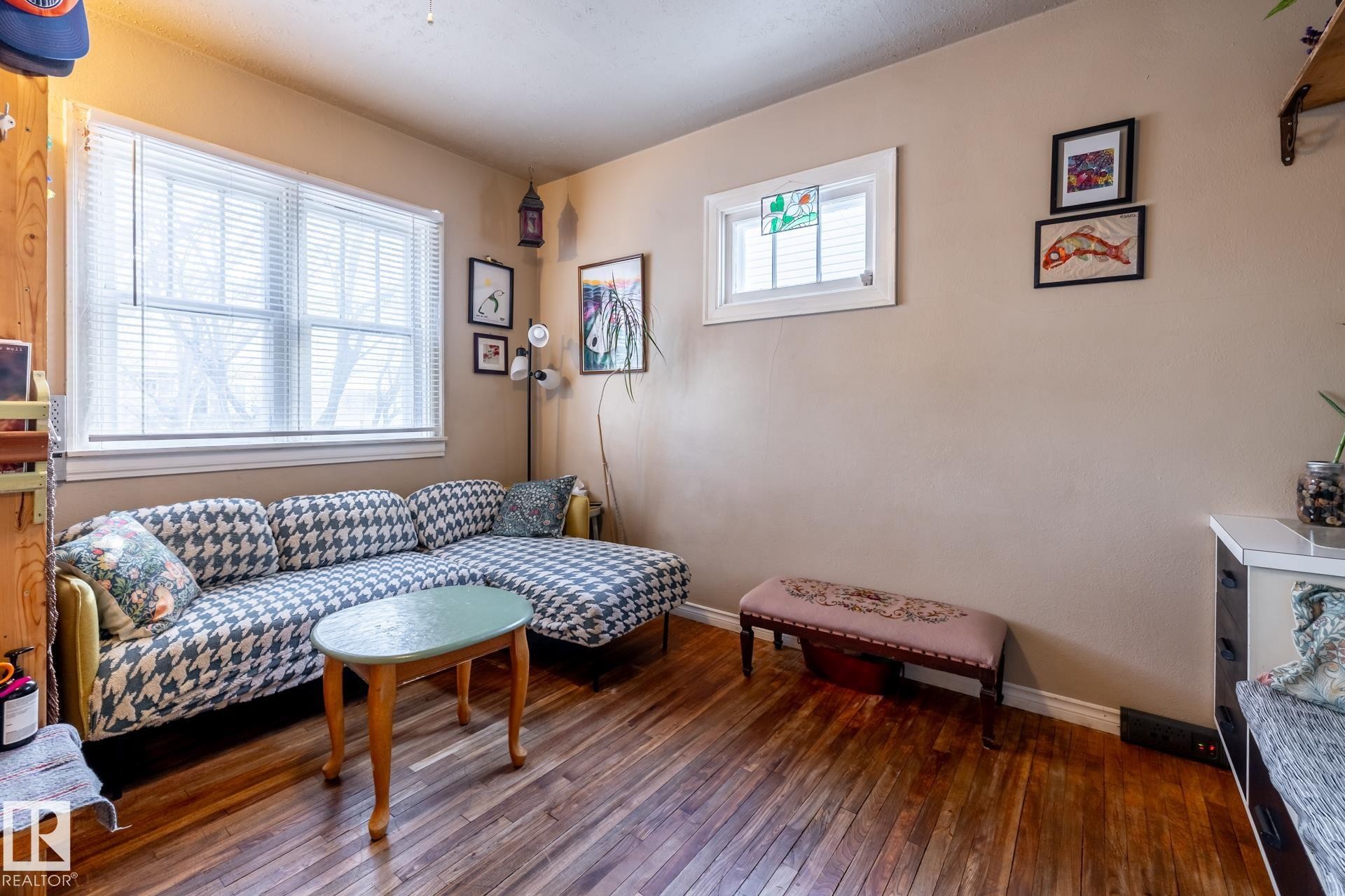 Living area featuring dark wood-type flooring and baseboards - 11240 84 Street, Edmonton, AB - Indoor