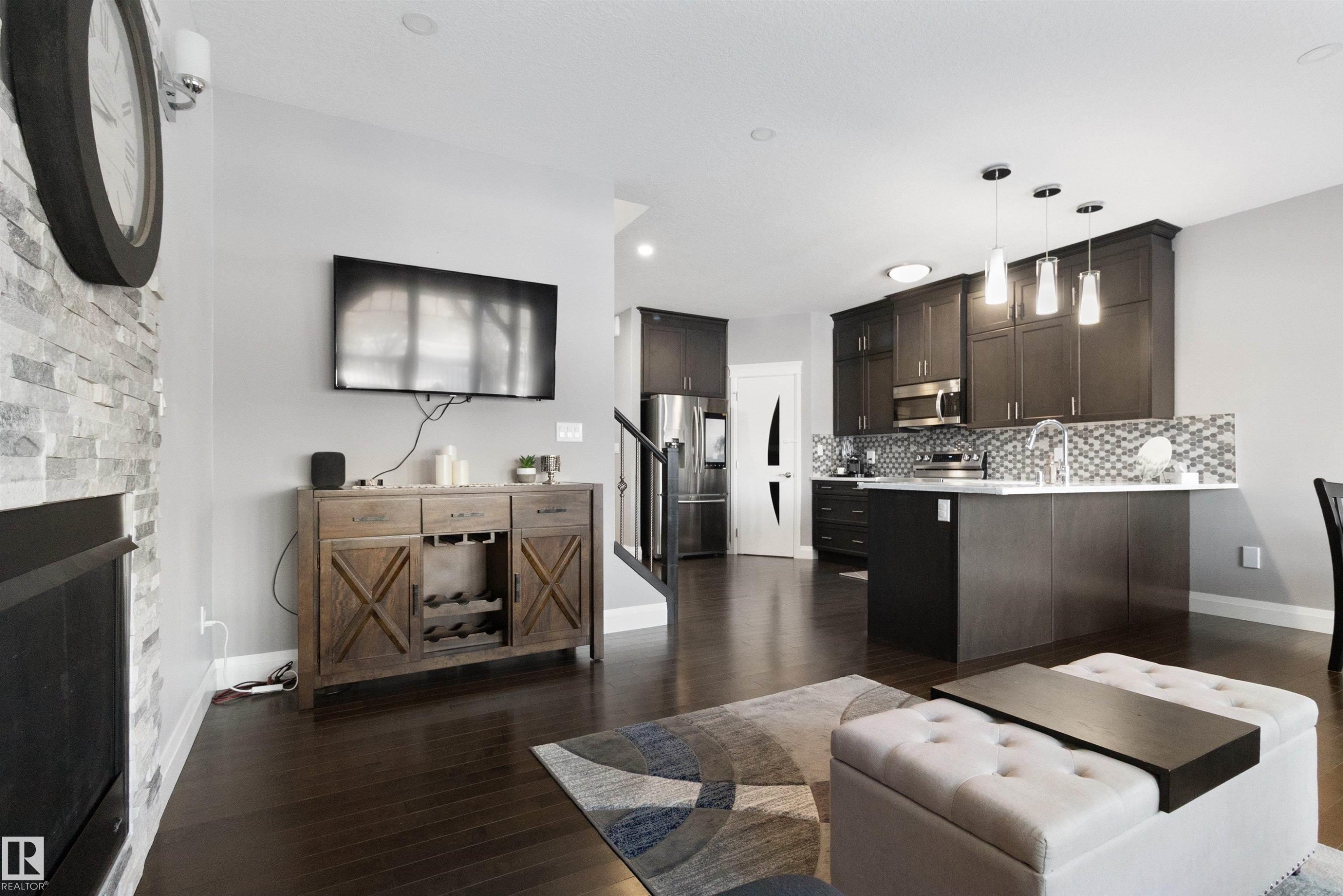 Living room with dark wood-type flooring and a fireplace - 56 Durrand Bend, Fort Saskatchewan, AB - Indoor
