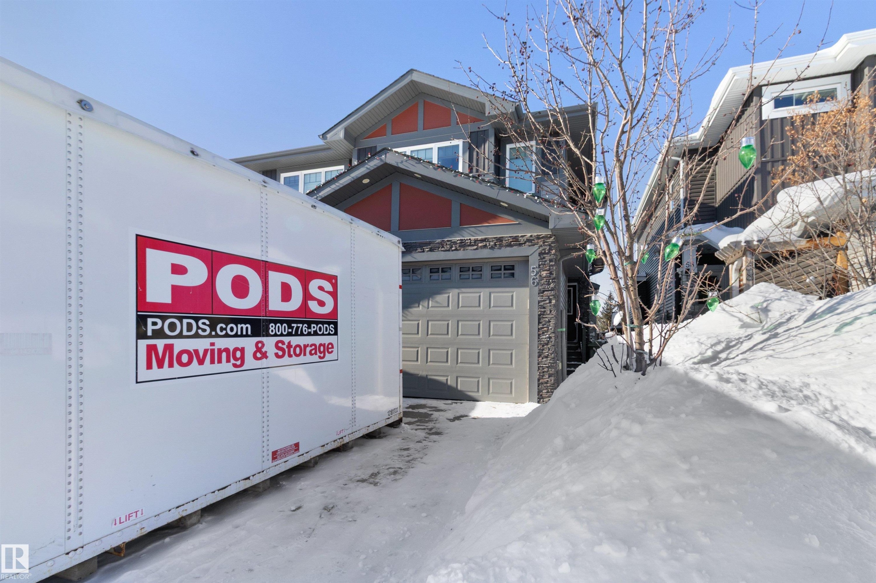 View of front of house featuring a garage and stone siding - 56 Durrand Bend, Fort Saskatchewan, AB - Outdoor