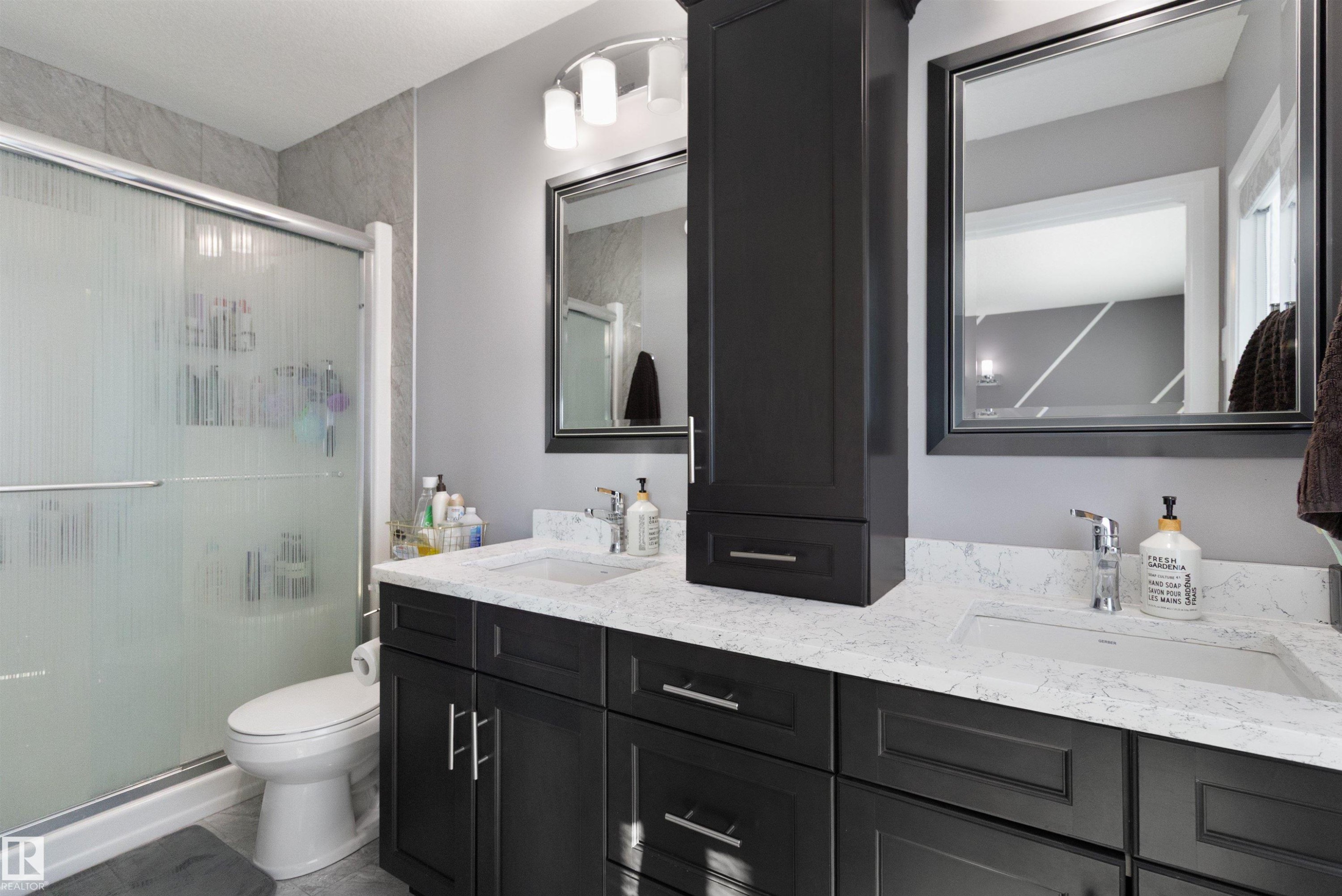 Full bath with double vanity and a stall shower - 56 Durrand Bend, Fort Saskatchewan, AB - Indoor Photo Showing Bathroom