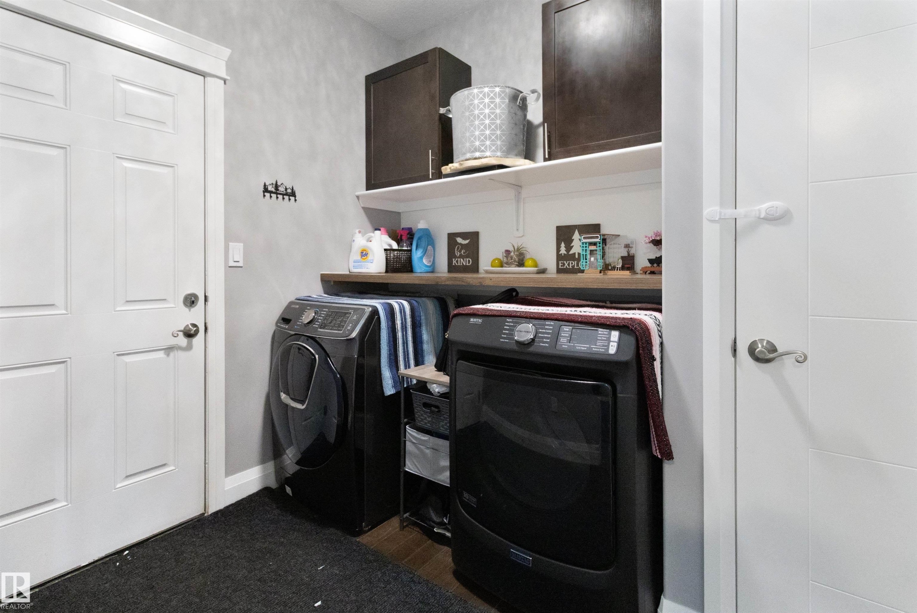 Laundry room with cabinet space and independent washer and dryer - 56 Durrand Bend, Fort Saskatchewan, AB - Indoor