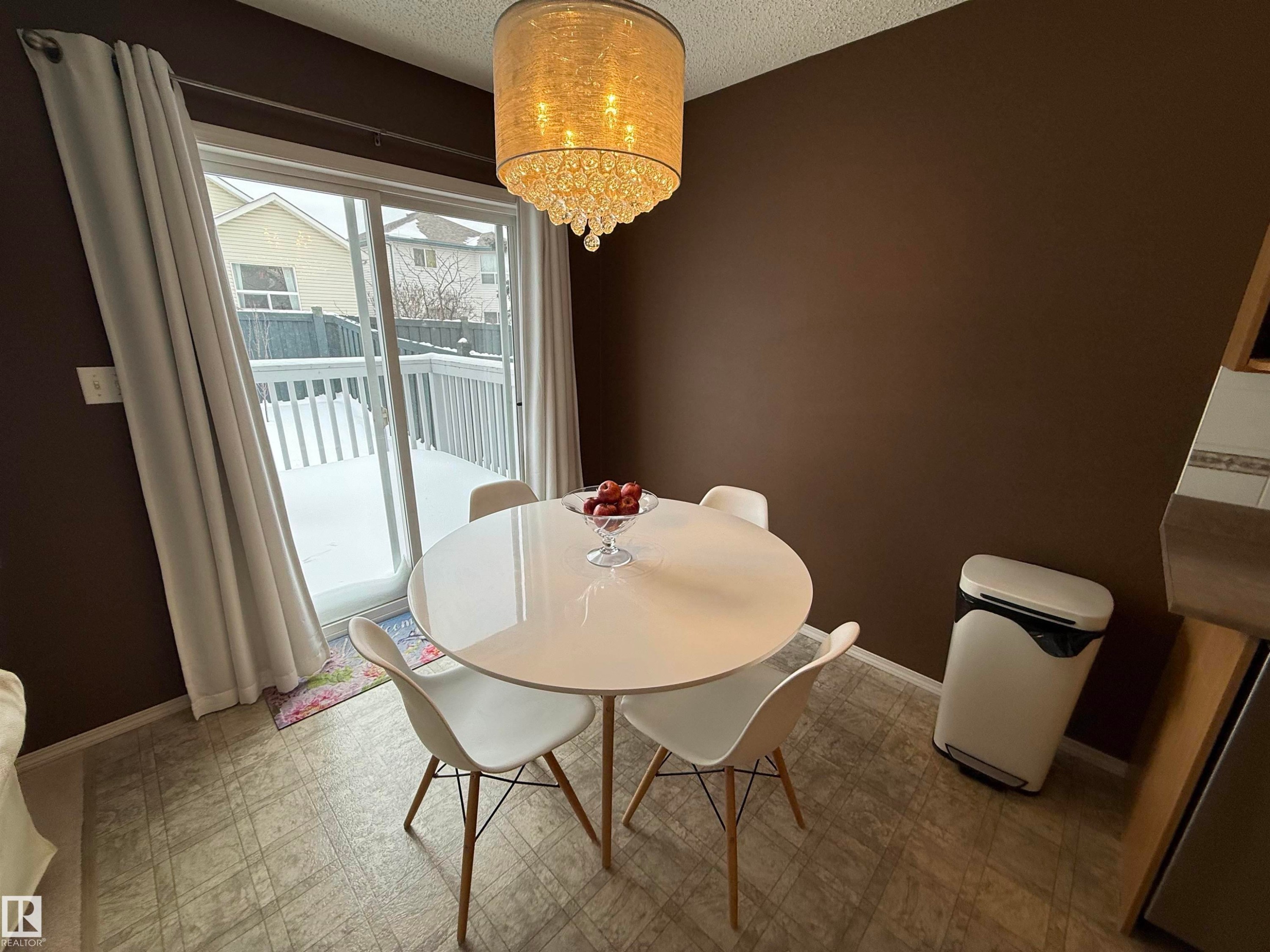 Dining space with light floors, suspended lighting, and a textured ceiling - 19 2021 Grantham Crest, Edmonton, AB - Indoor Photo Showing Dining Room