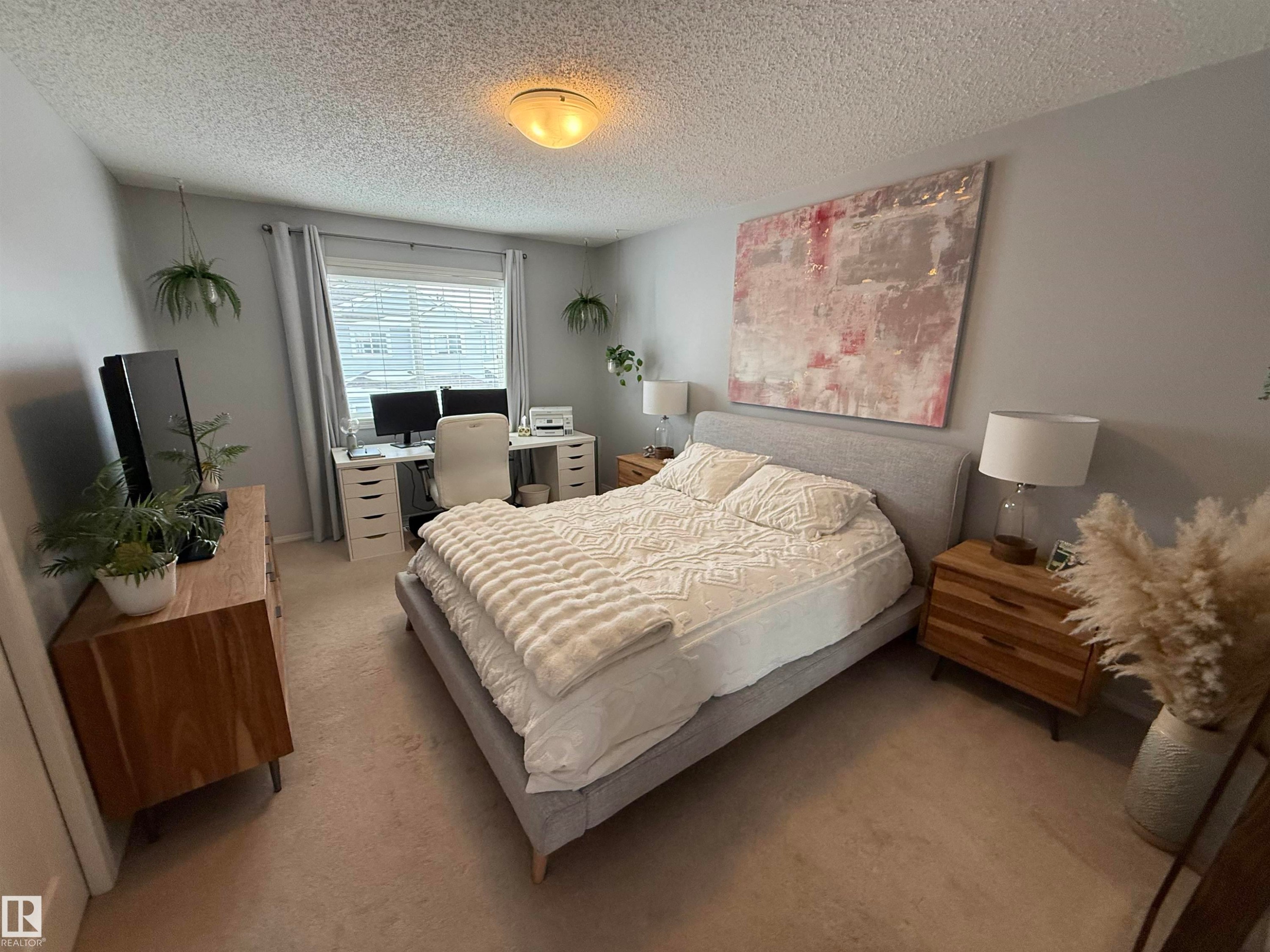 Carpeted bedroom with a desk and a textured ceiling - 19 2021 Grantham Crest, Edmonton, AB - Indoor Photo Showing Bedroom