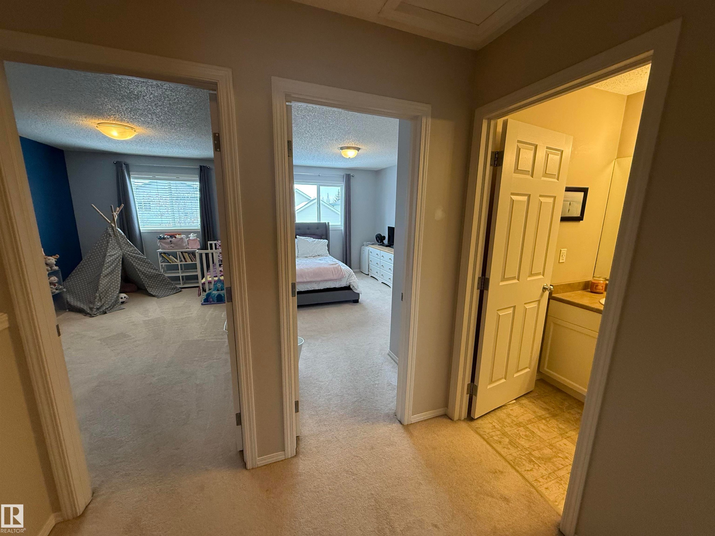 Hall with light colored carpet and a textured ceiling - 19 2021 Grantham Crest, Edmonton, AB - Indoor Photo Showing Other Room