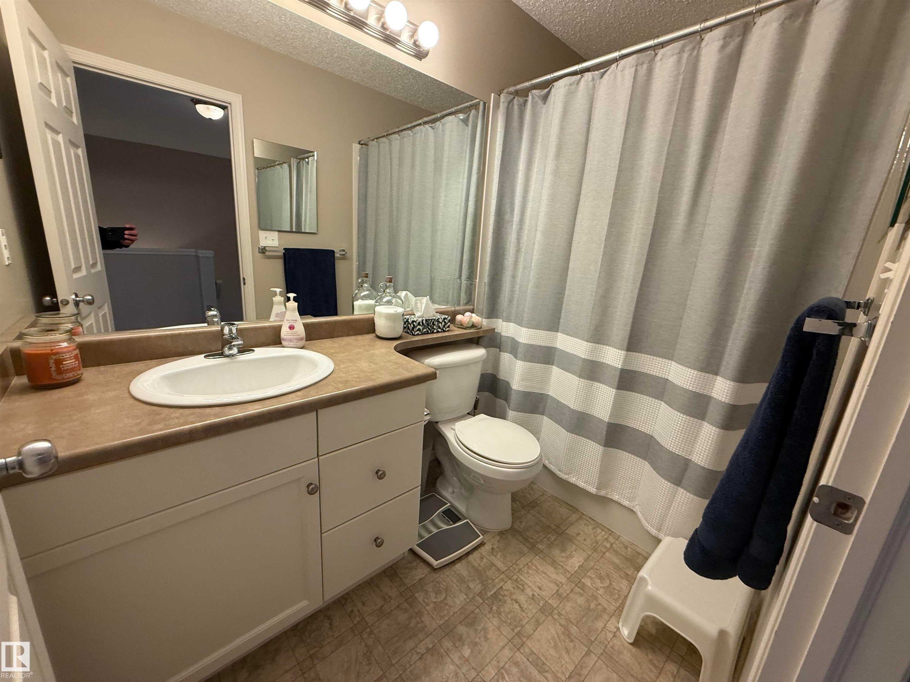 Bathroom featuring vanity, a shower with curtain, and a textured ceiling - 19 2021 Grantham Crest, Edmonton, AB - Indoor Photo Showing Bathroom