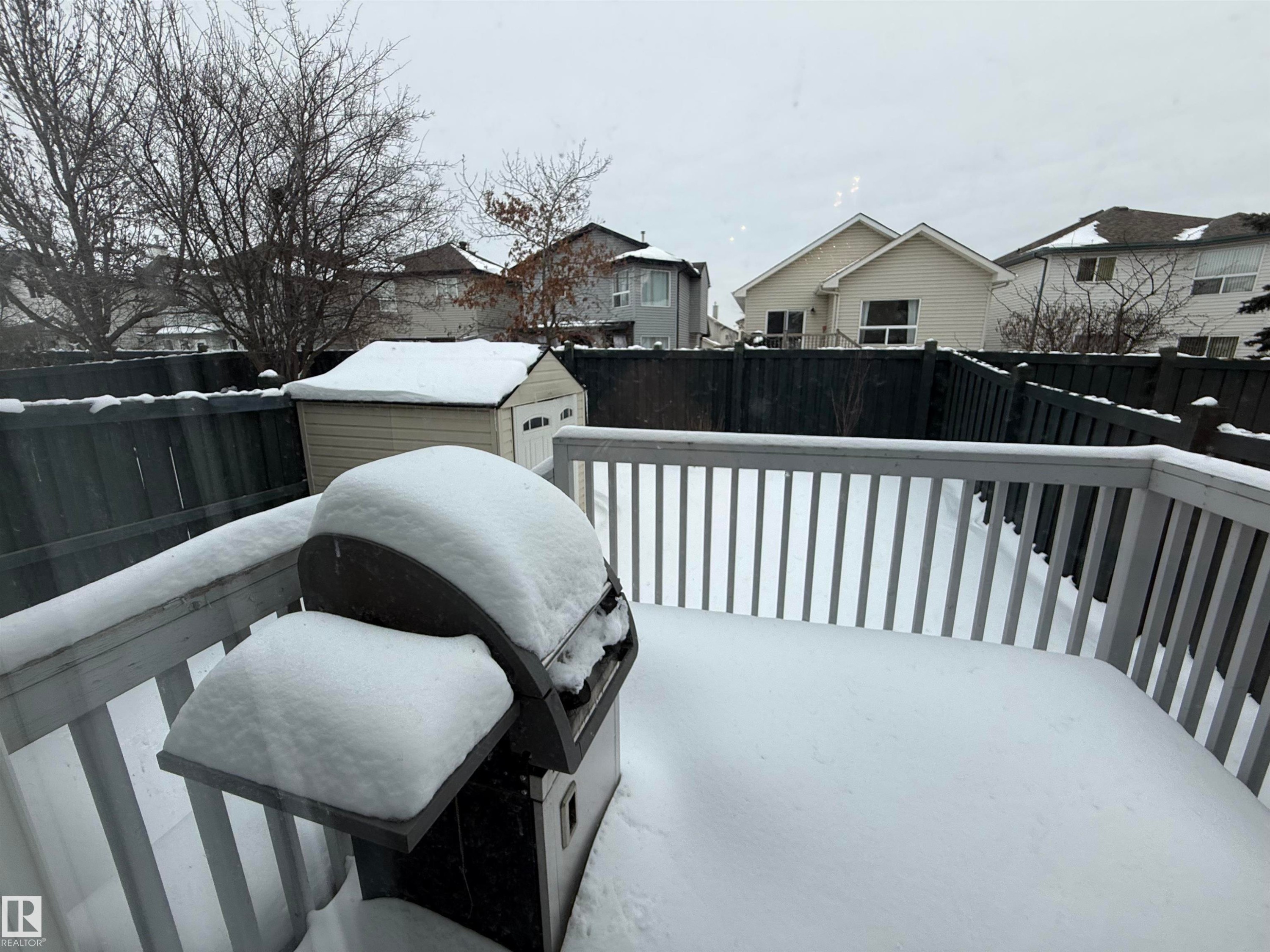 Deck with area for grilling, a fenced backyard, and a residential view - 19 2021 Grantham Crest, Edmonton, AB - Outdoor