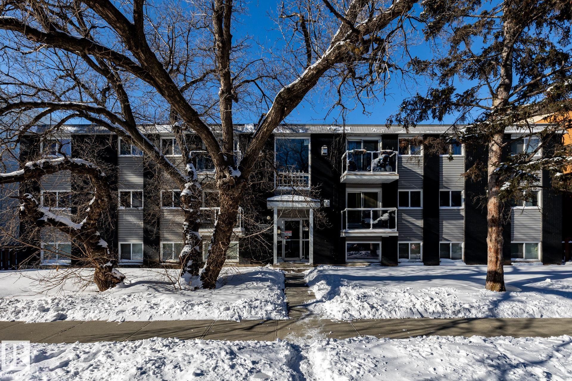 Snow covered building featuring a view of apartment building / complex - 15 10620 122 Street, Edmonton, AB - Outdoor With Facade