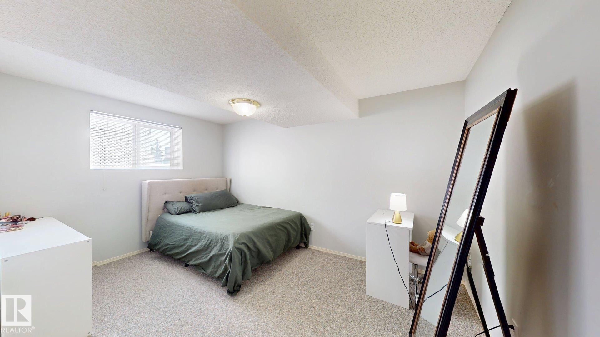 Bedroom with a textured ceiling and light colored carpet - 17010 84 Street, Edmonton, AB - Indoor Photo Showing Bedroom