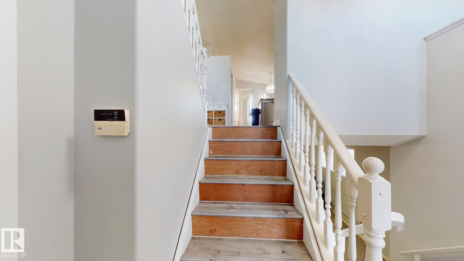 Stairway featuring wood finished floors - 17010 84 Street, Edmonton, AB - Indoor Photo Showing Other Room