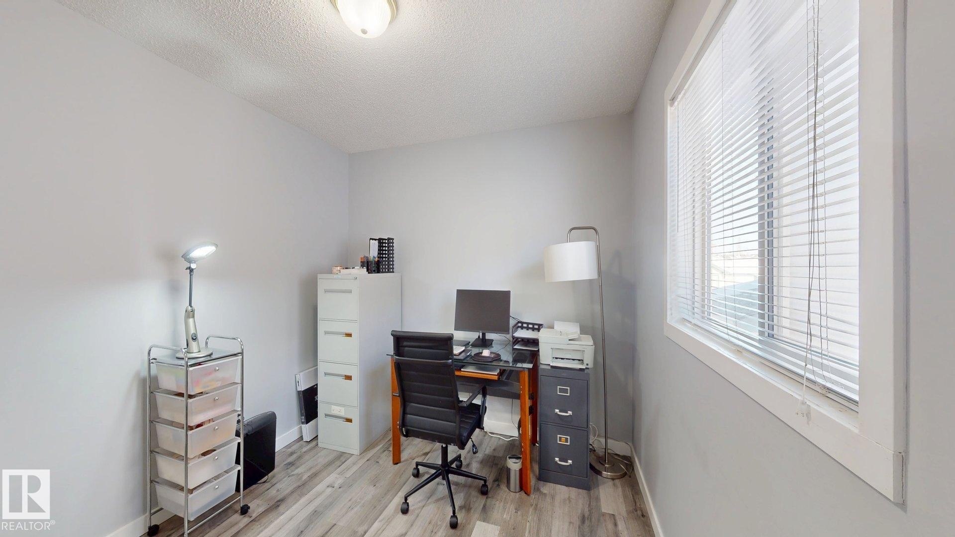 Office space featuring light wood-style floors and a textured ceiling - 17010 84 Street, Edmonton, AB - Indoor Photo Showing Office