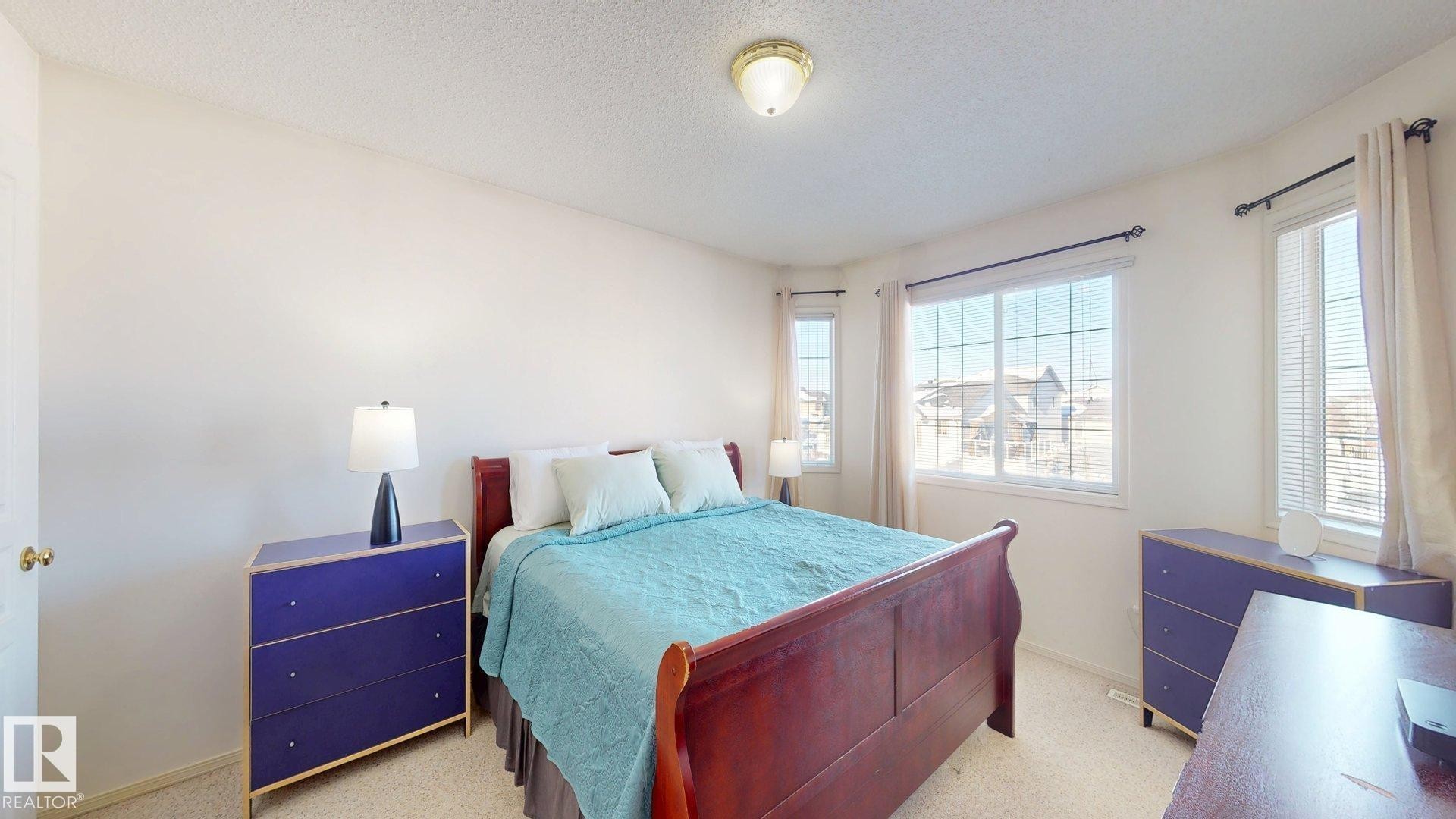 Bedroom featuring a textured ceiling and light colored carpet - 17010 84 Street, Edmonton, AB - Indoor Photo Showing Bedroom