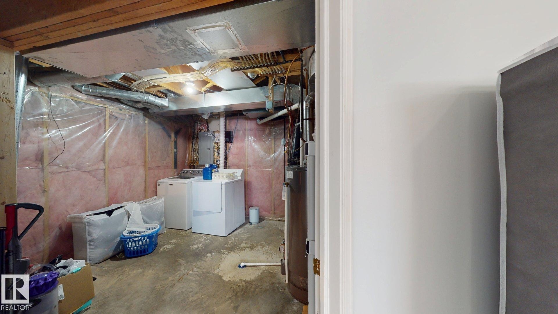 Unfinished basement with washer and clothes dryer, electric panel, and water heater - 17010 84 Street, Edmonton, AB - Indoor Photo Showing Basement