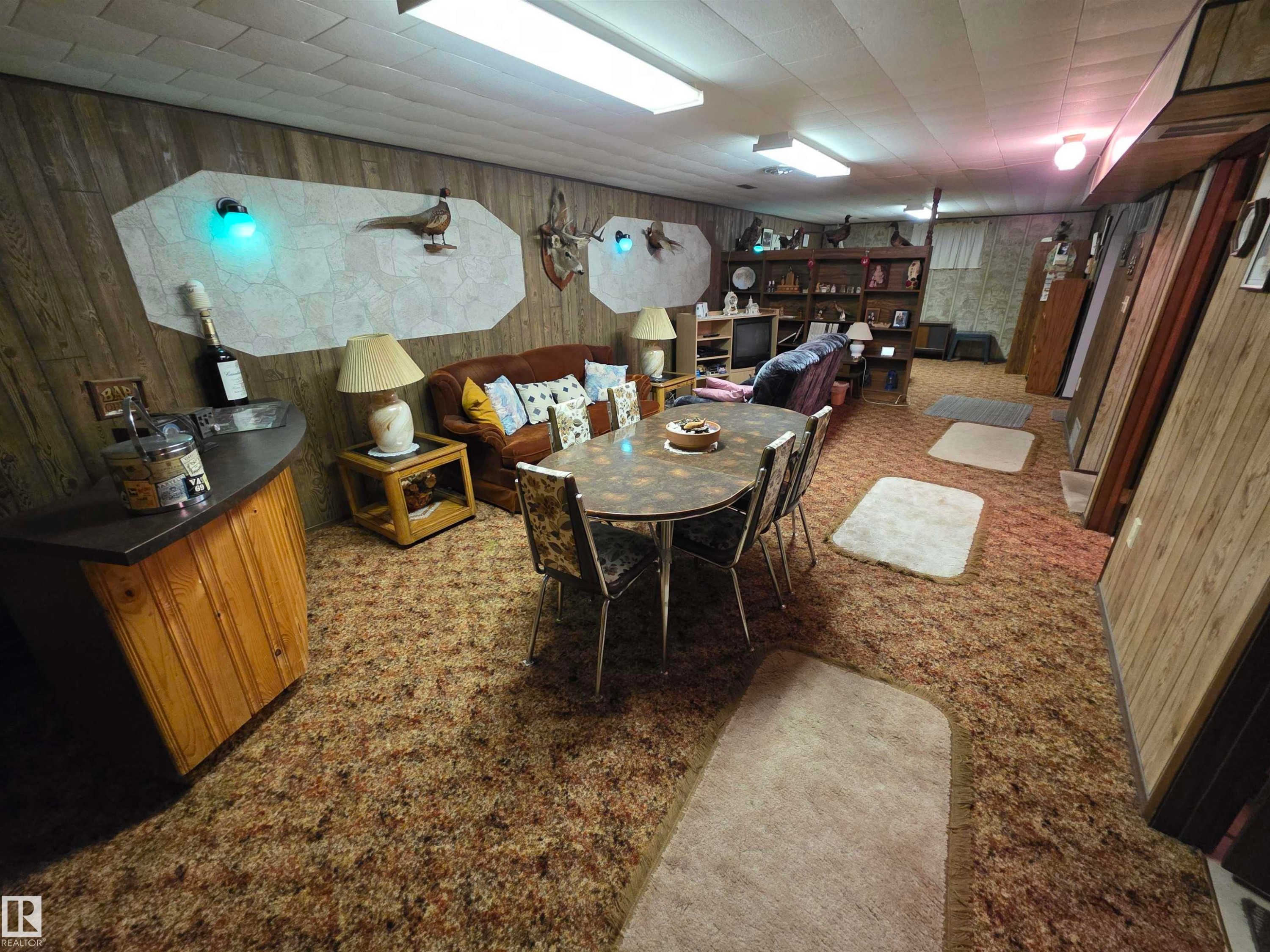 Dining area featuring wooden walls - 4400 45 Avenue, Stony Plain, AB - Indoor Photo Showing Other Room