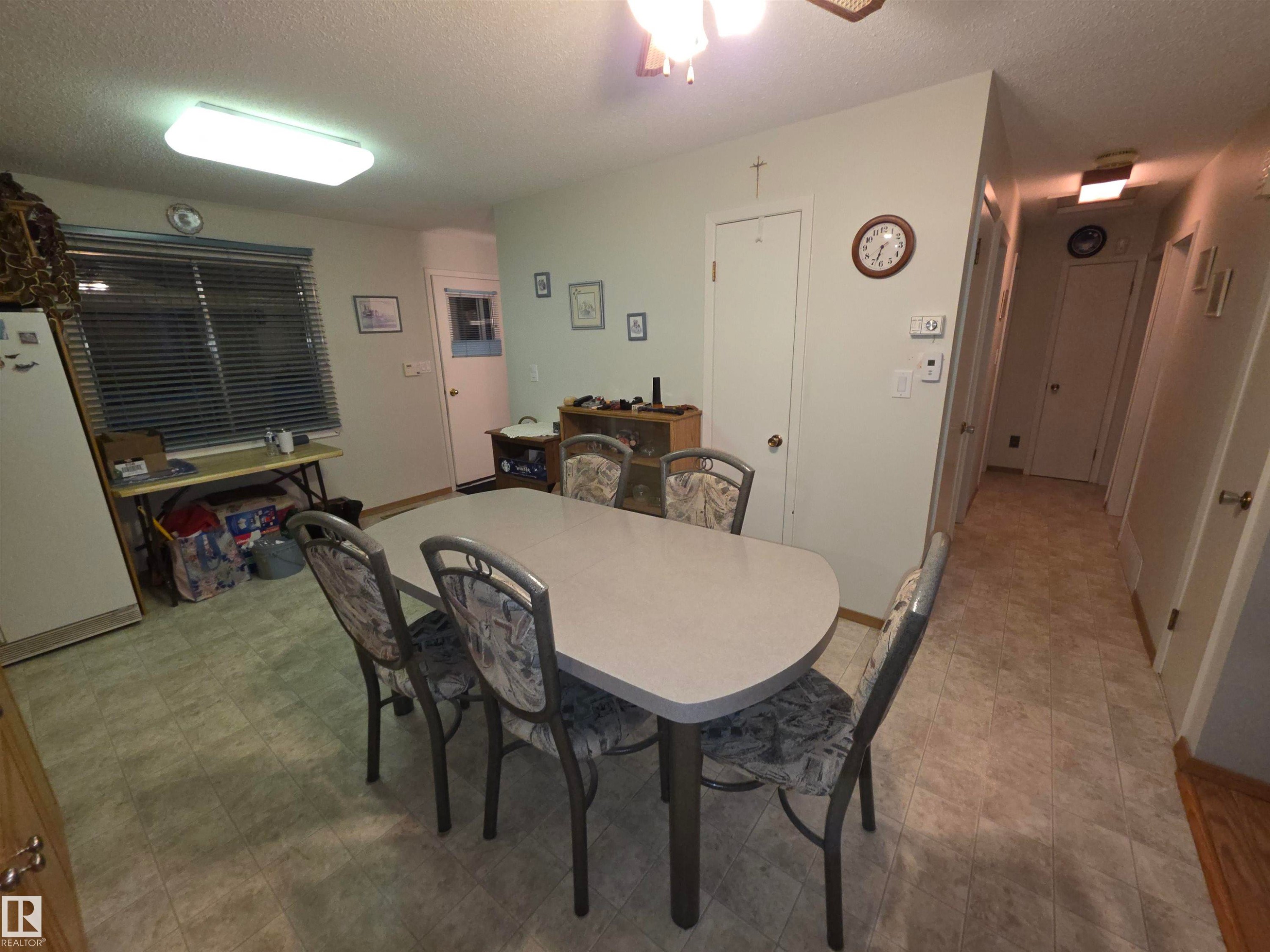 Dining room featuring a textured ceiling, a ceiling fan, and light floors - 4400 45 Avenue, Stony Plain, AB - Indoor Photo Showing Dining Room
