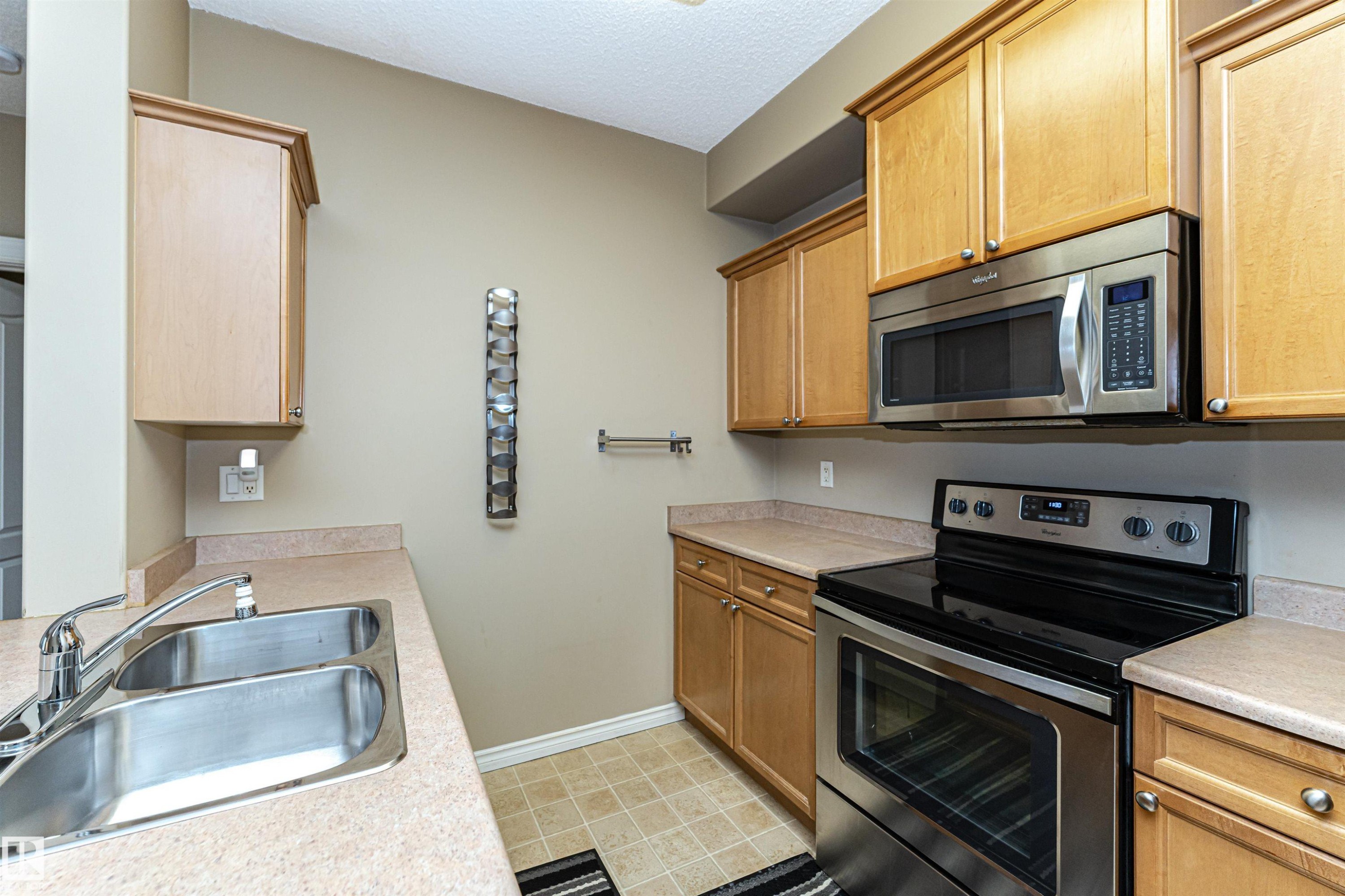 227 16807 100 Avenue, Edmonton, AB - Indoor Photo Showing Kitchen With Stainless Steel Kitchen With Double Sink