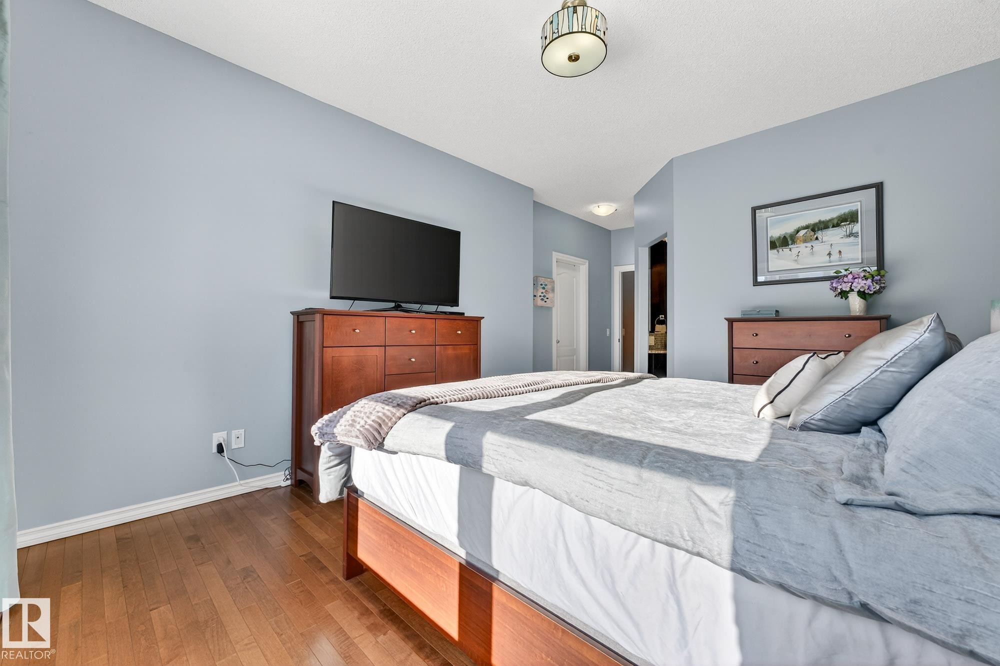 Bedroom with hardwood / wood-style flooring and ensuite bath - 2036 Hilliard Place, Edmonton, AB - Indoor Photo Showing Bedroom