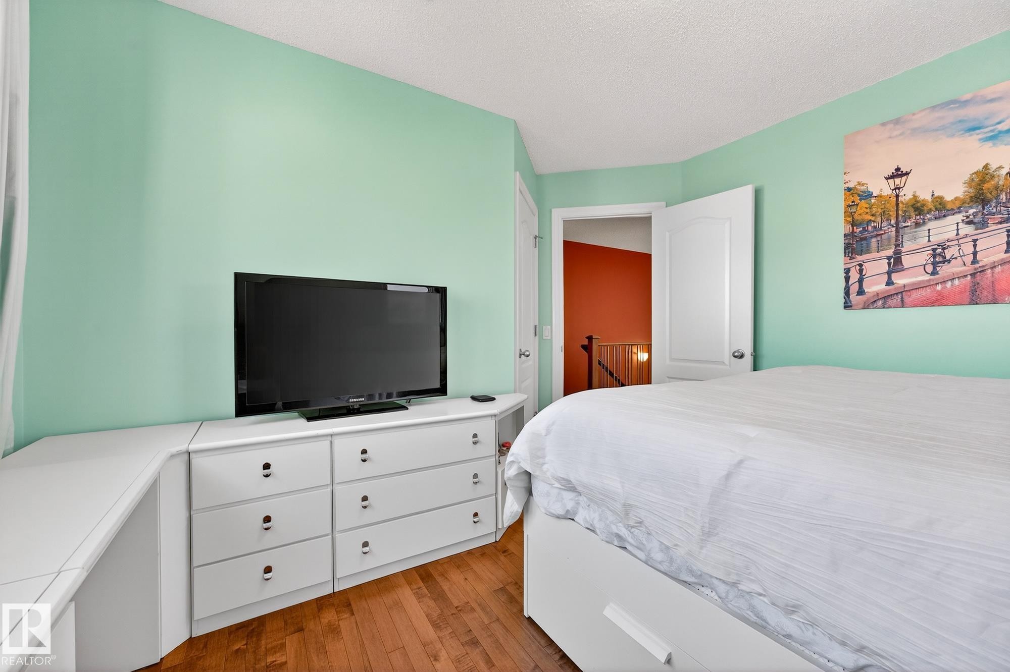 Bedroom with light wood-style floors and a textured ceiling - 2036 Hilliard Place, Edmonton, AB - Indoor Photo Showing Bedroom