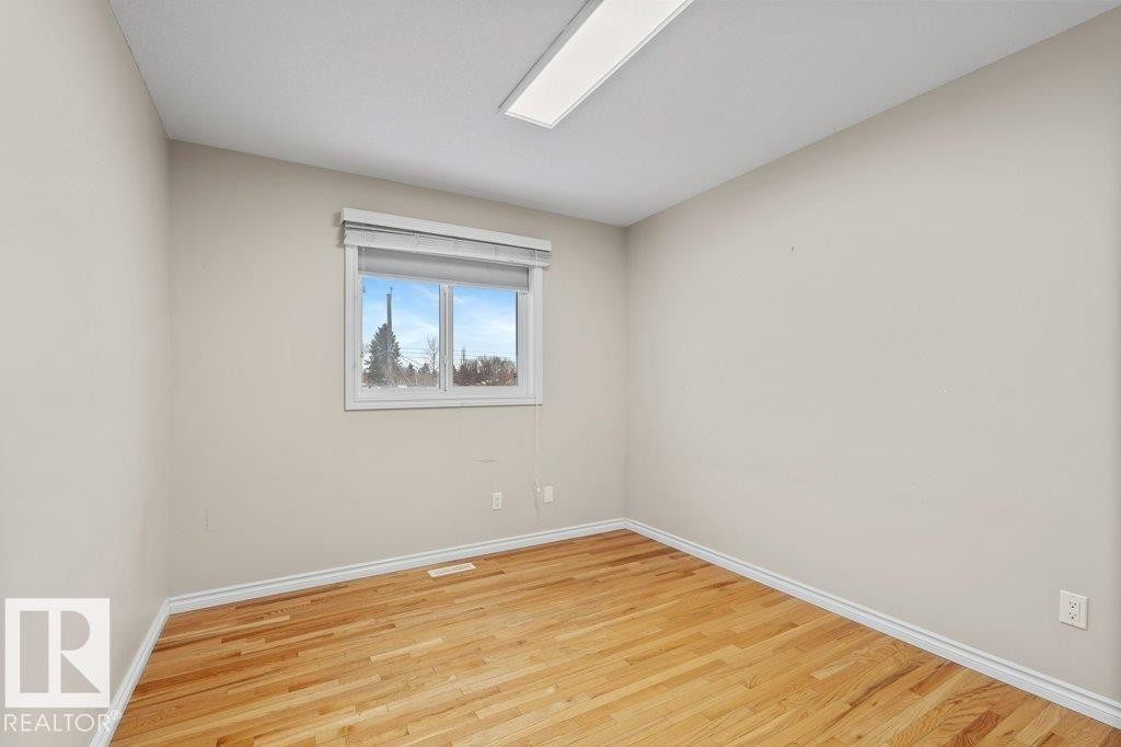 Empty room with light wood-style floors and baseboards - 10639 70 Avenue, Edmonton, AB - Indoor Photo Showing Other Room