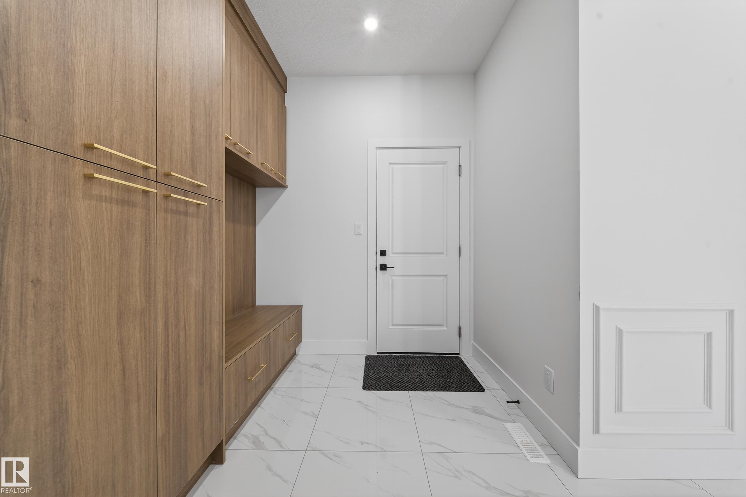 Mudroom with light marble finish floors and recessed lighting - 4006 40 Street, Beaumont, AB - Indoor Photo Showing Other Room
