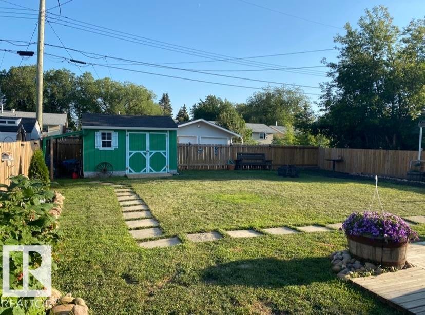 Fenced backyard featuring a storage shed - 4919 50 Avenue, Bon Accord, AB - Outdoor