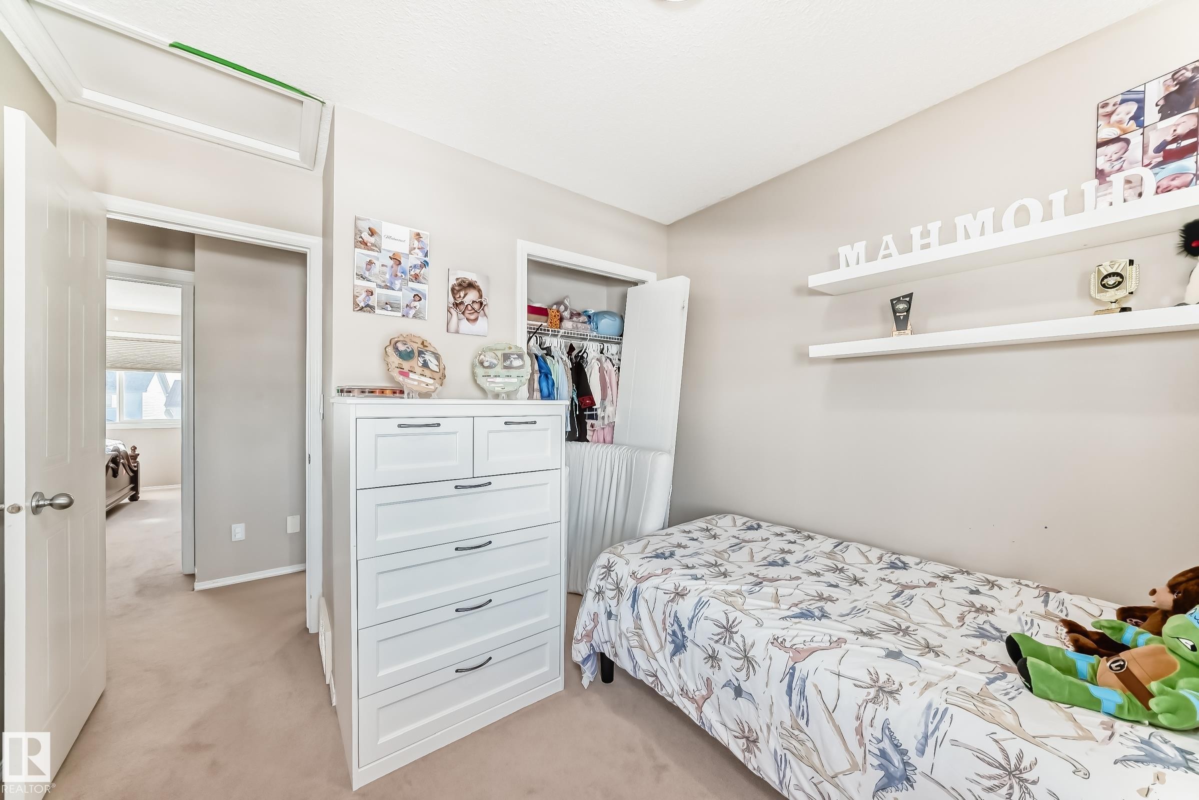 Bedroom with light colored carpet and a closet - 14043 151 Avenue, Edmonton, AB - Indoor Photo Showing Bedroom