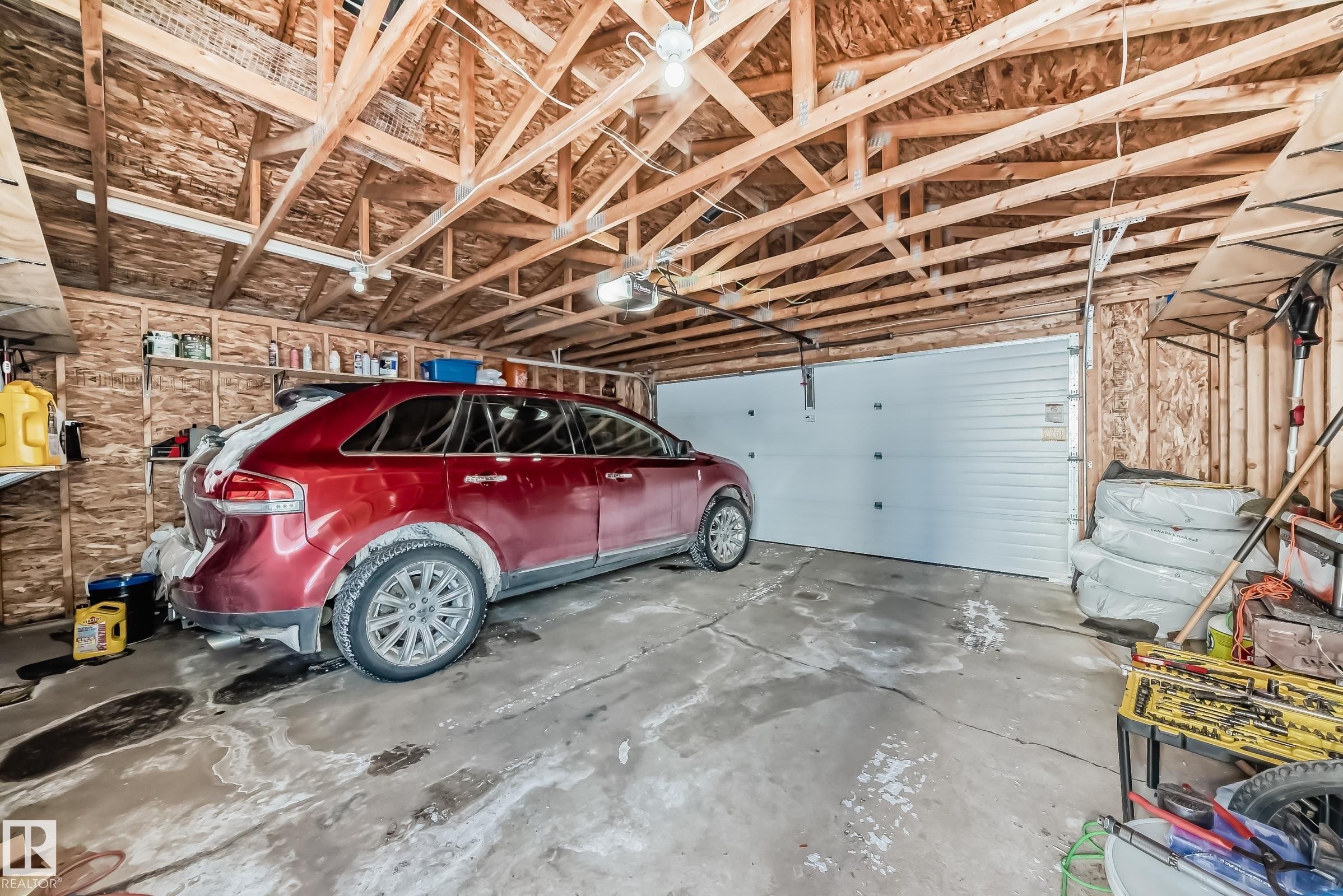 Garage featuring a garage door opener - 14043 151 Avenue, Edmonton, AB - Indoor Photo Showing Garage