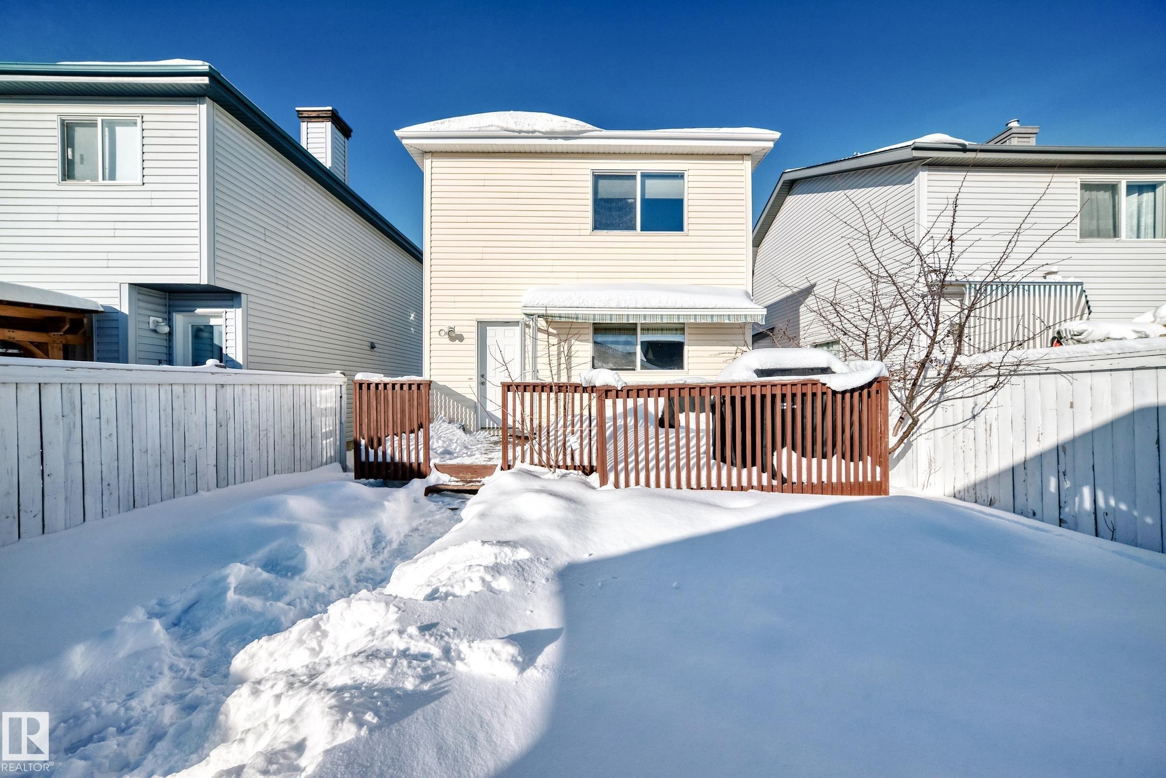 Snow covered property with a wooden deck - 14043 151 Avenue, Edmonton, AB - Outdoor With Exterior