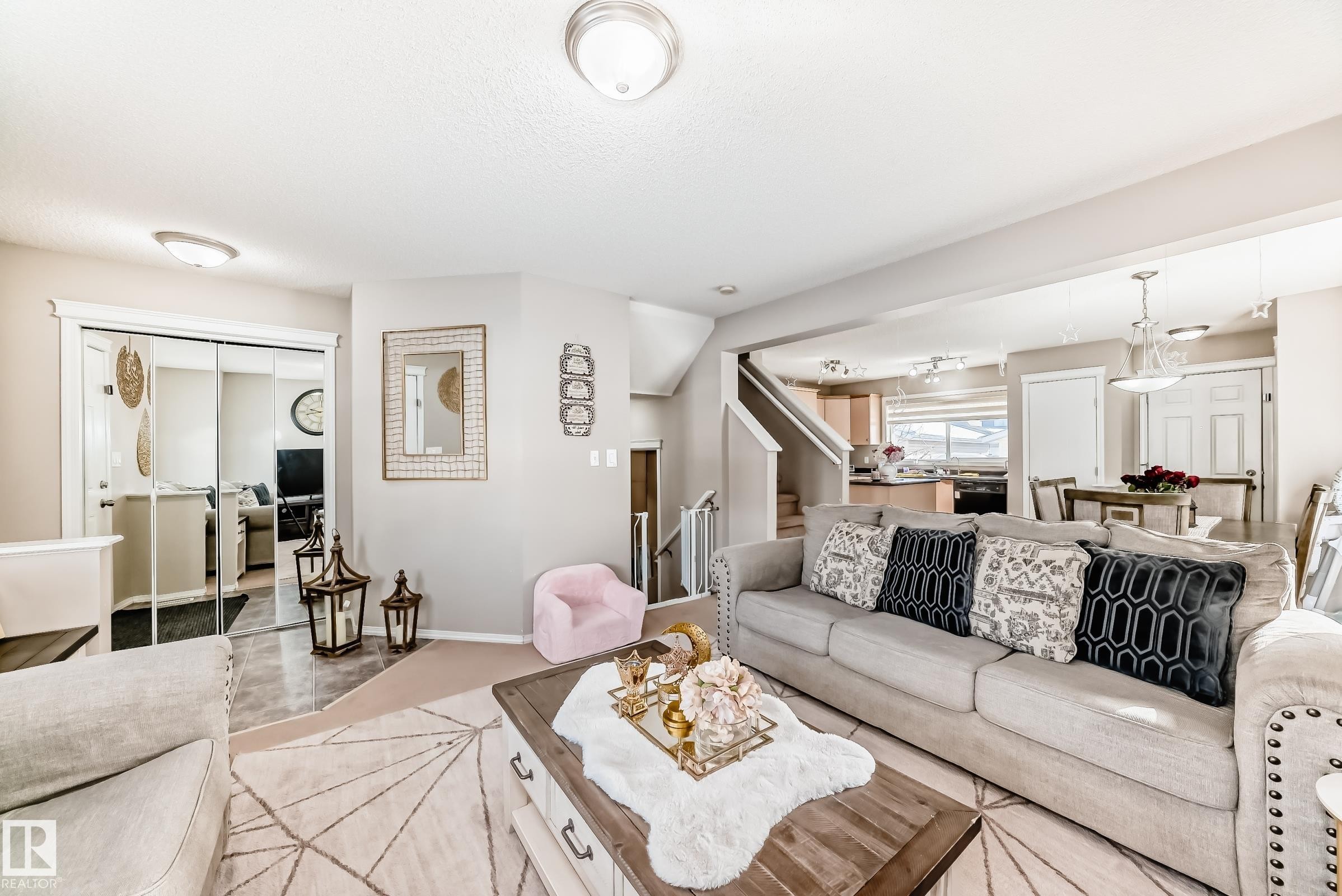 Living room with stairs and baseboards - 14043 151 Avenue, Edmonton, AB - Indoor Photo Showing Living Room