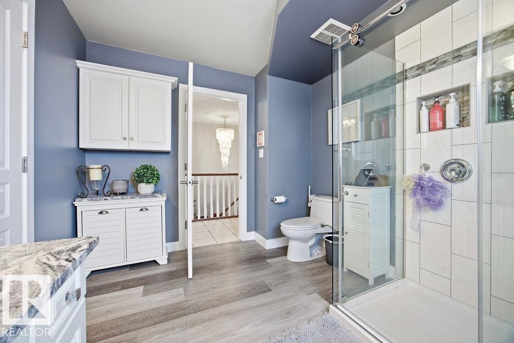 Bathroom with vanity, a stall shower, and light wood-type flooring - 3011 44A Street, Edmonton, AB - Indoor Photo Showing Bathroom