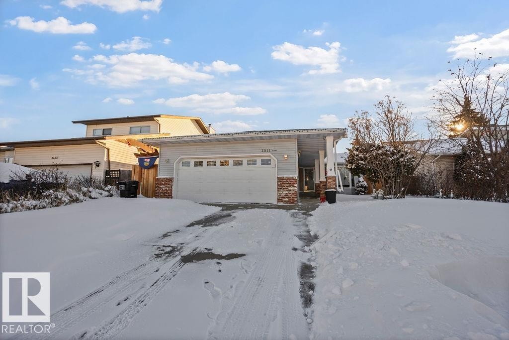 View of front facade featuring a garage and brick siding - 3011 44A Street, Edmonton, AB - Outdoor