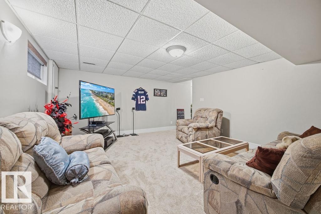 Living area featuring a drop ceiling and carpet floors - 3011 44A Street, Edmonton, AB - Indoor