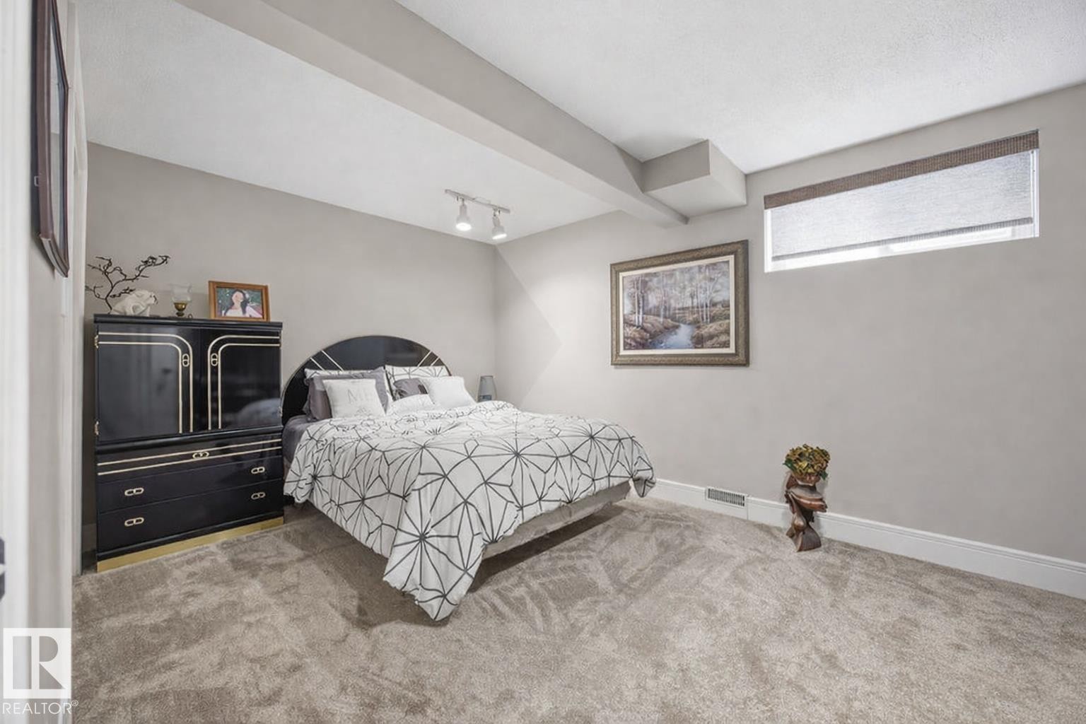 Carpeted bedroom featuring track lighting and baseboards - 3011 44A Street, Edmonton, AB - Indoor Photo Showing Bedroom