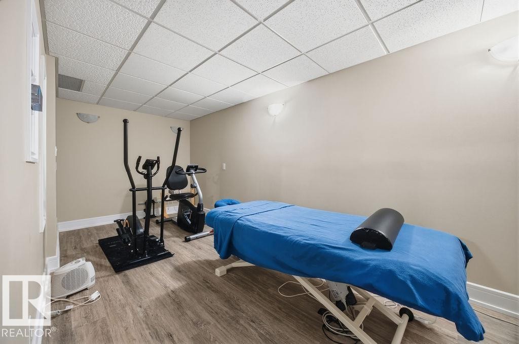 Bedroom featuring a drop ceiling and wood finished floors - 3011 44A Street, Edmonton, AB - Indoor