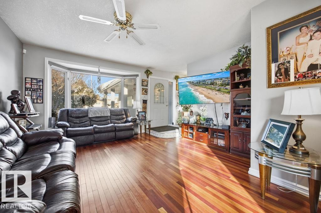 Living area featuring light wood-type flooring and ceiling fan - 3011 44A Street, Edmonton, AB - Indoor Photo Showing Living Room