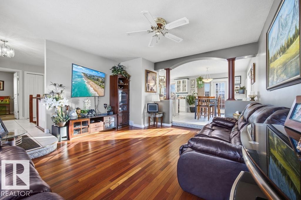 Living room with arched walkways, decorative columns, a ceiling fan, and hardwood / wood-style flooring - 3011 44A Street, Edmonton, AB - Indoor Photo Showing Living Room