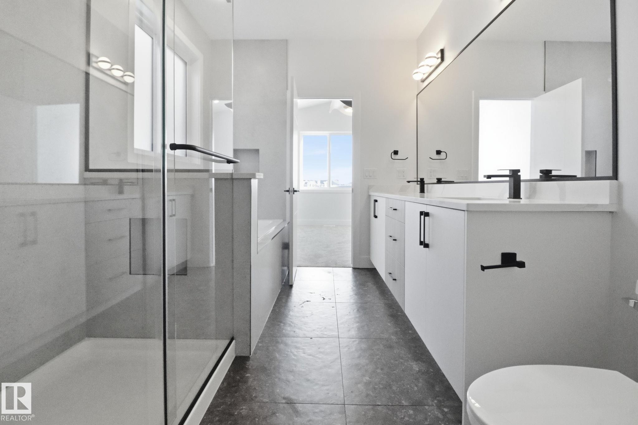 Full bath with double vanity and a stall shower - 90 Eldridge Point(E), St. Albert, AB - Indoor Photo Showing Bathroom