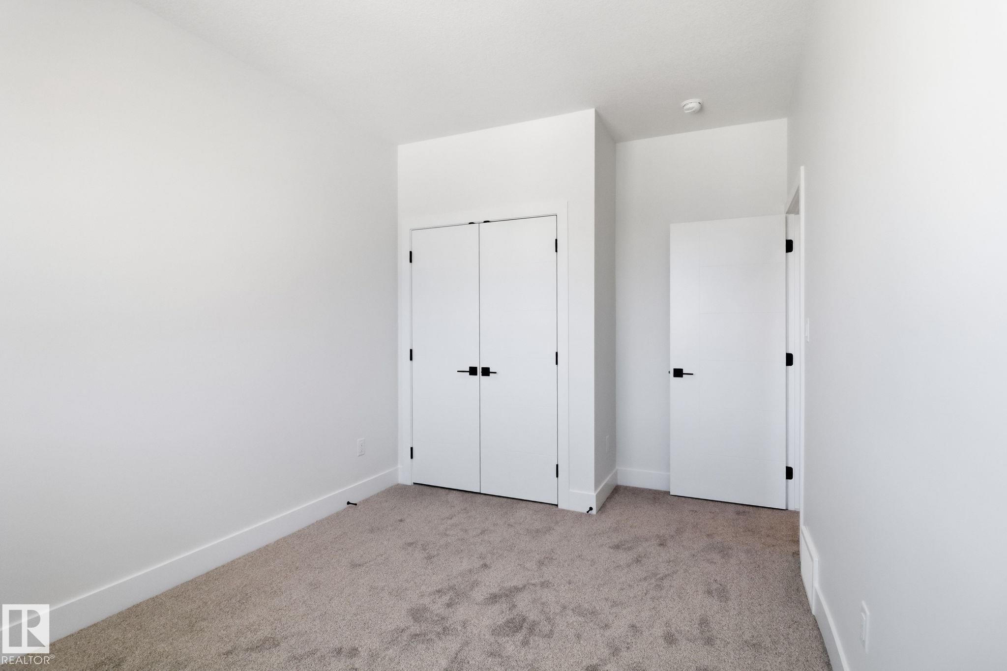 Unfurnished bedroom featuring light carpet and a closet - 90 Eldridge Point(E), St. Albert, AB - Indoor Photo Showing Other Room
