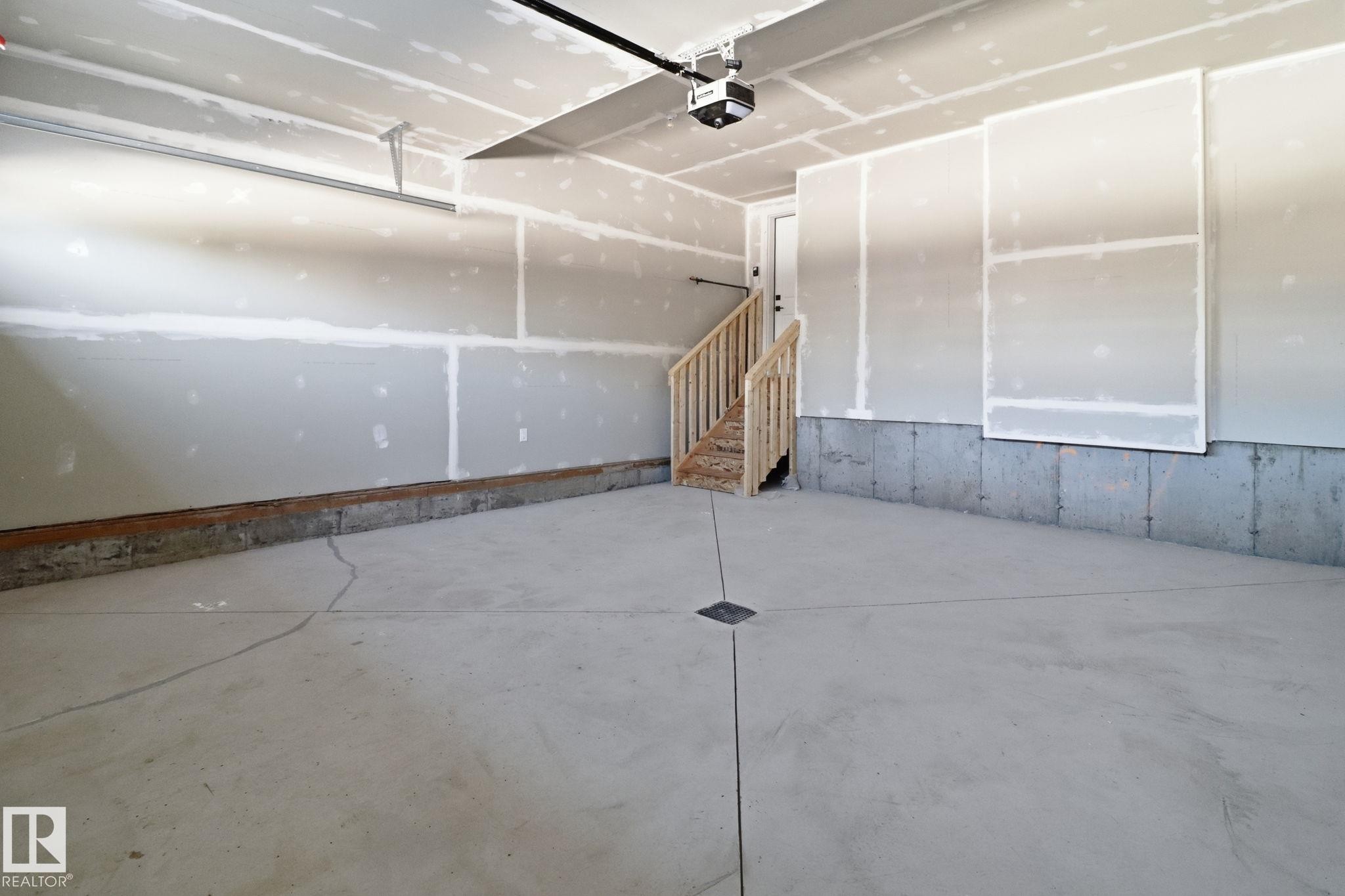 Garage with a garage door opener - 90 Eldridge Point(E), St. Albert, AB - Indoor Photo Showing Other Room
