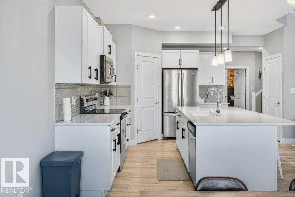 View from the kitchen nook area into the bright and open kitchen layout. - 1909 Davidson Wynd, Edmonton, AB - Indoor Photo Showing Kitchen With Upgraded Kitchen