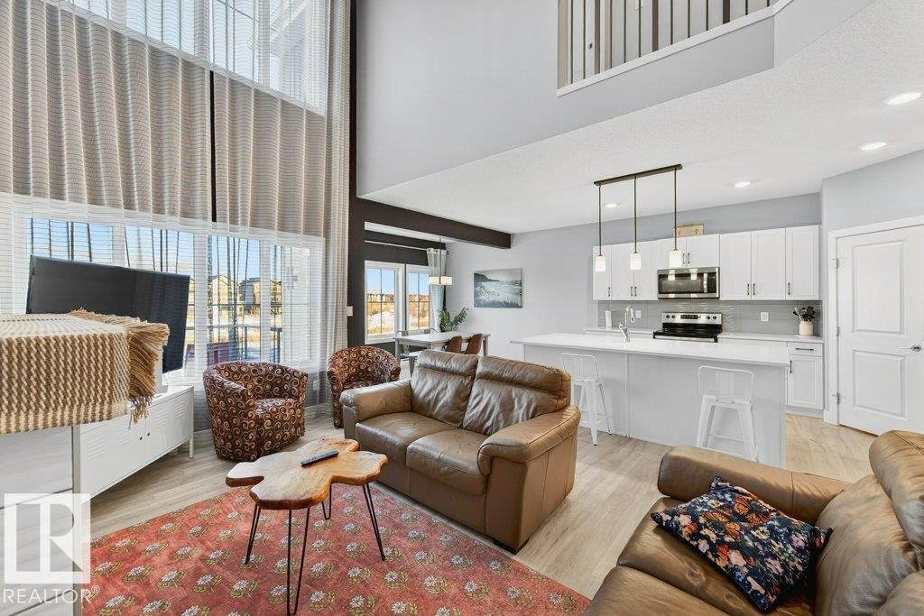 View from the great room into the kitchen and kitchen nook. - 1909 Davidson Wynd, Edmonton, AB - Indoor Photo Showing Living Room