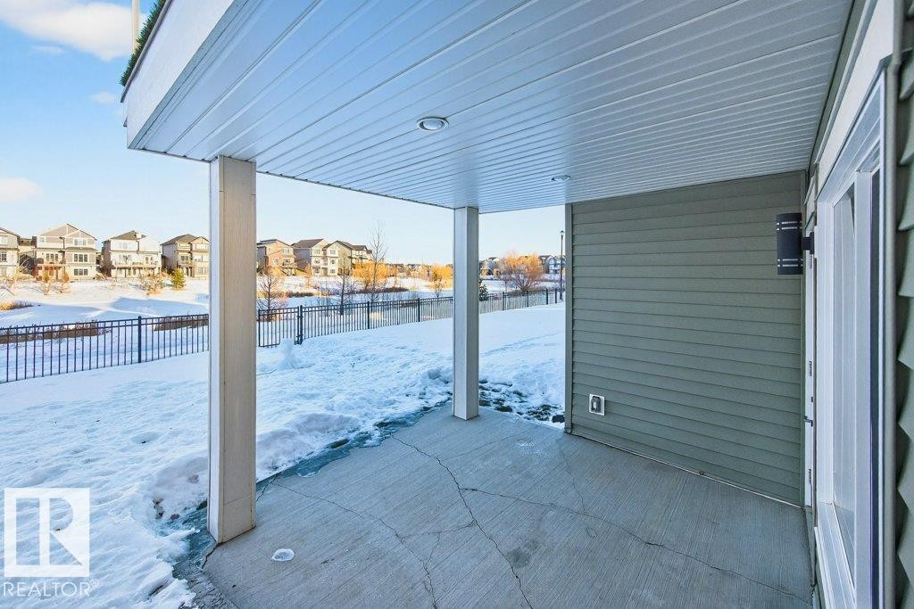 Covered walkout patio under main floor deck. - 1909 Davidson Wynd, Edmonton, AB - Outdoor With Exterior