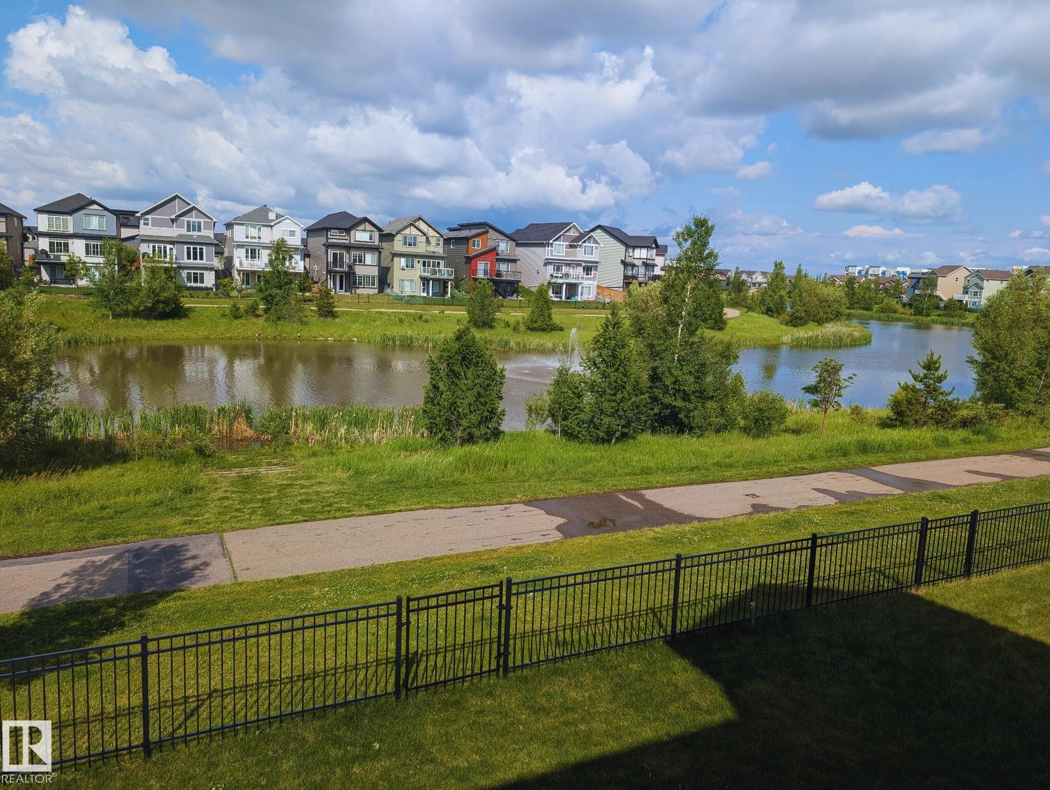 Pond and fountain - view during summer months. - 1909 Davidson Wynd, Edmonton, AB - Outdoor With Body Of Water With View