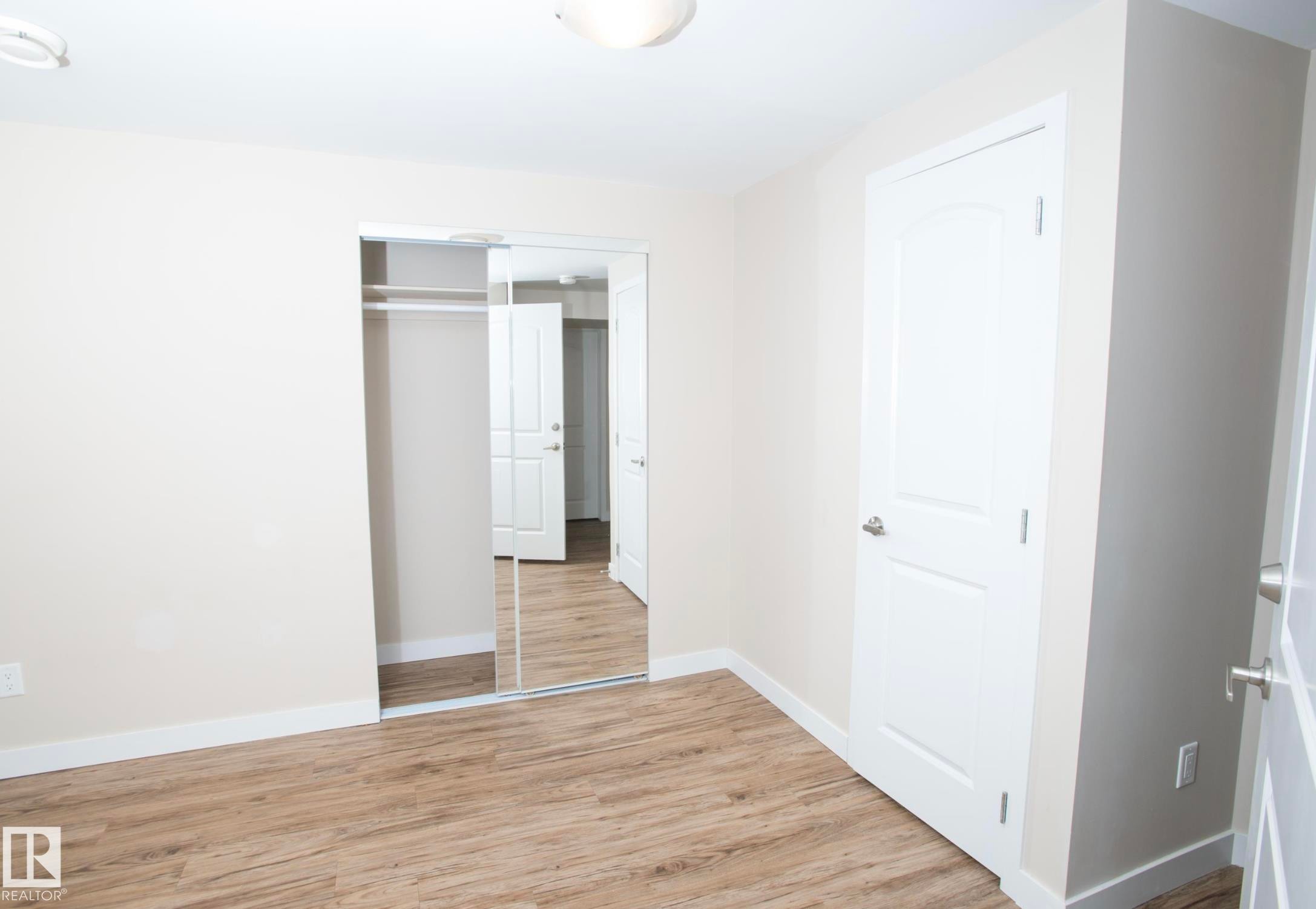Unfurnished bedroom featuring light wood finished floors and a closet - 13616 82 Street Nw, Edmonton, AB - Indoor Photo Showing Other Room