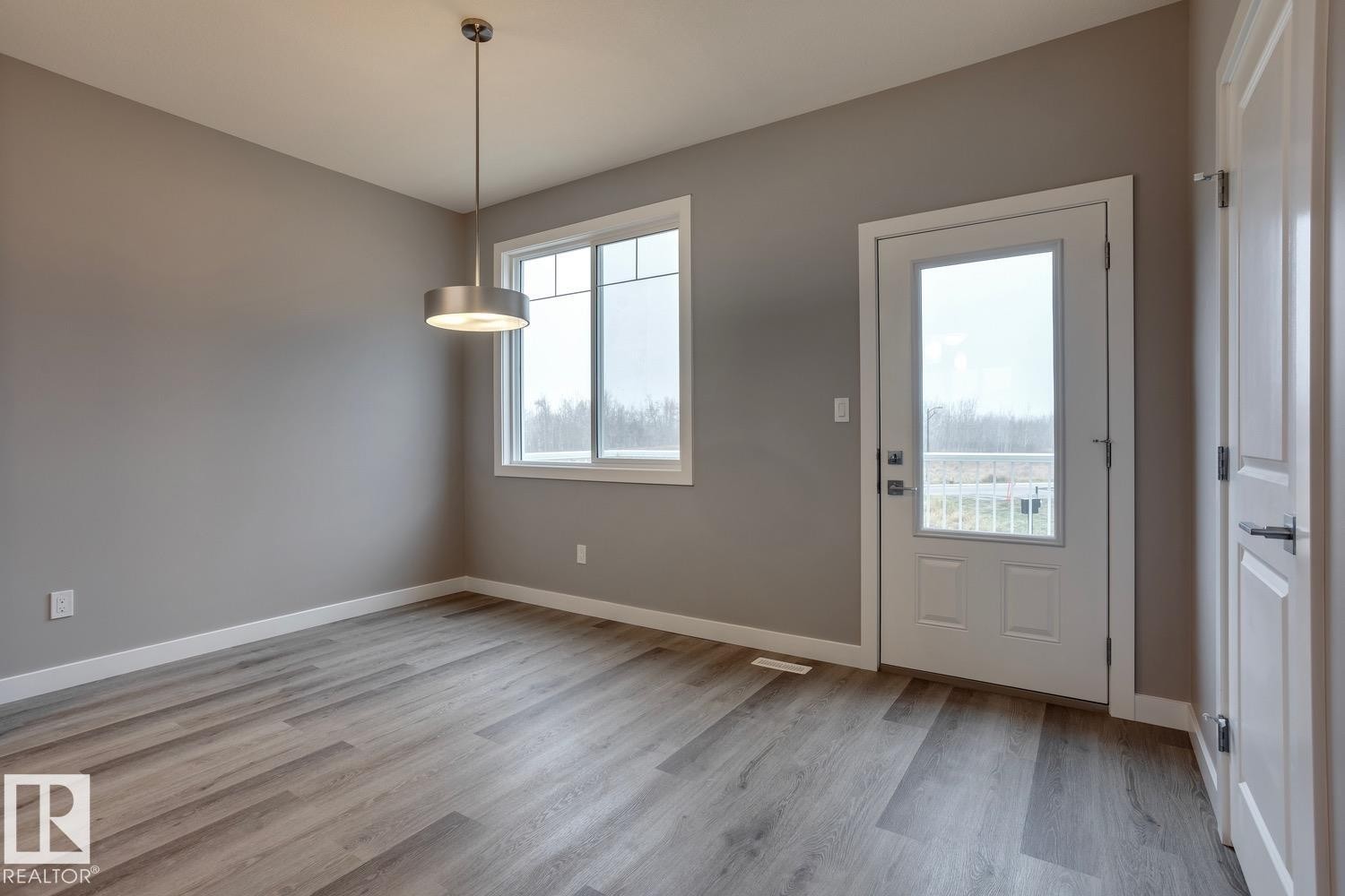 Foyer entrance with light wood-style floors and baseboards - 78 13139 205 Street Nw, Edmonton, AB - Indoor Photo Showing Other Room